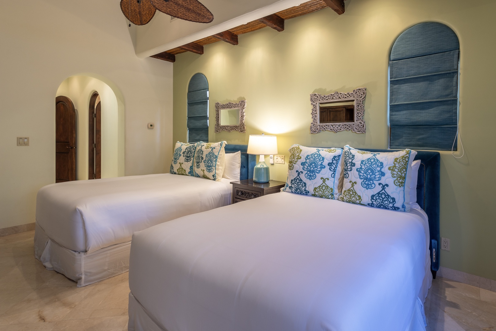 Unwind in your serene twin bedroom, where rustic wood beams and calming blue accents create a peaceful sanctuary. Rest easy on plush beds surrounded by thoughtful details and soft lighting for your perfect night's sleep.