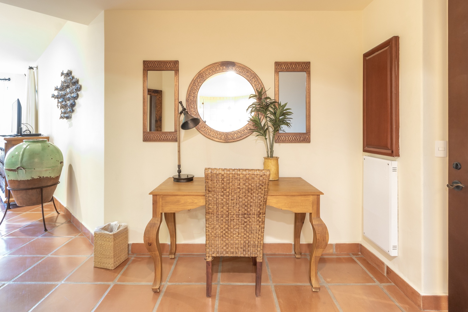 Settle into your own cozy workspace with natural light streaming through decorative mirrors, warm wood furnishings, and charming details that make working feel like a pleasure.