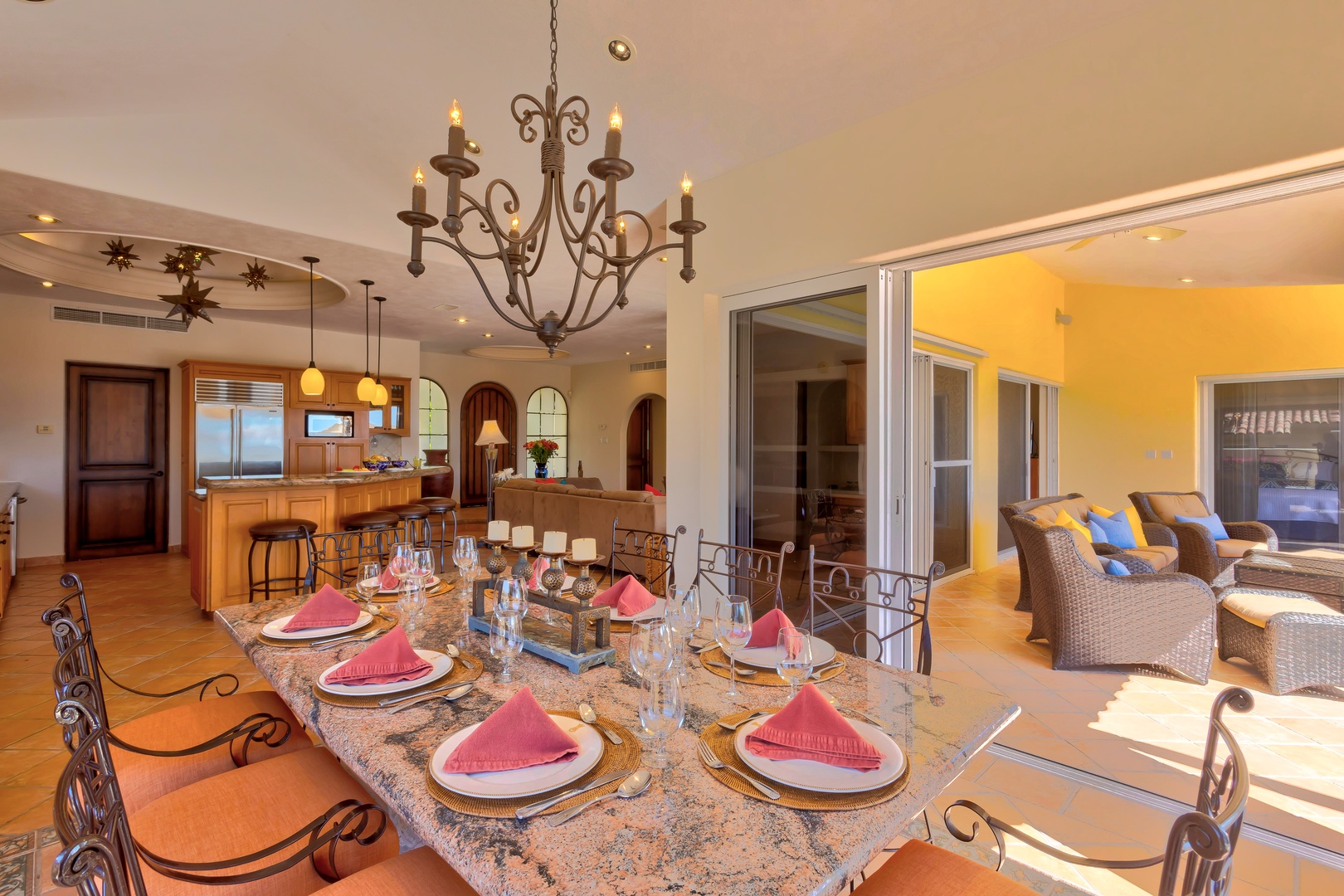 Gather around this elegant dining table where memorable meals await, with your gourmet kitchen and sunset terrace just steps away.