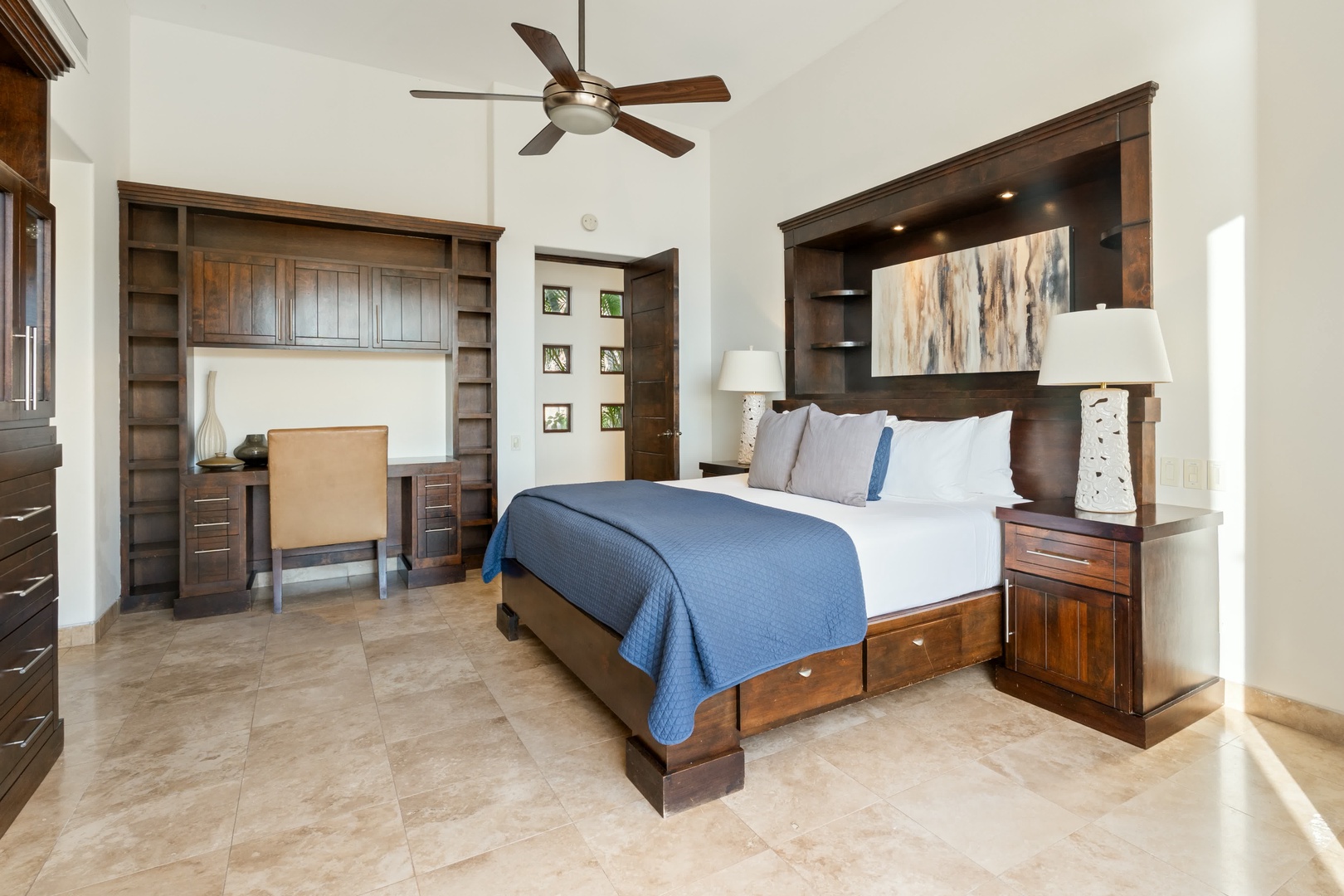 Your spacious bedroom features rich wood furnishings, crisp linens, and a built-in workspace for ultimate comfort and convenience.