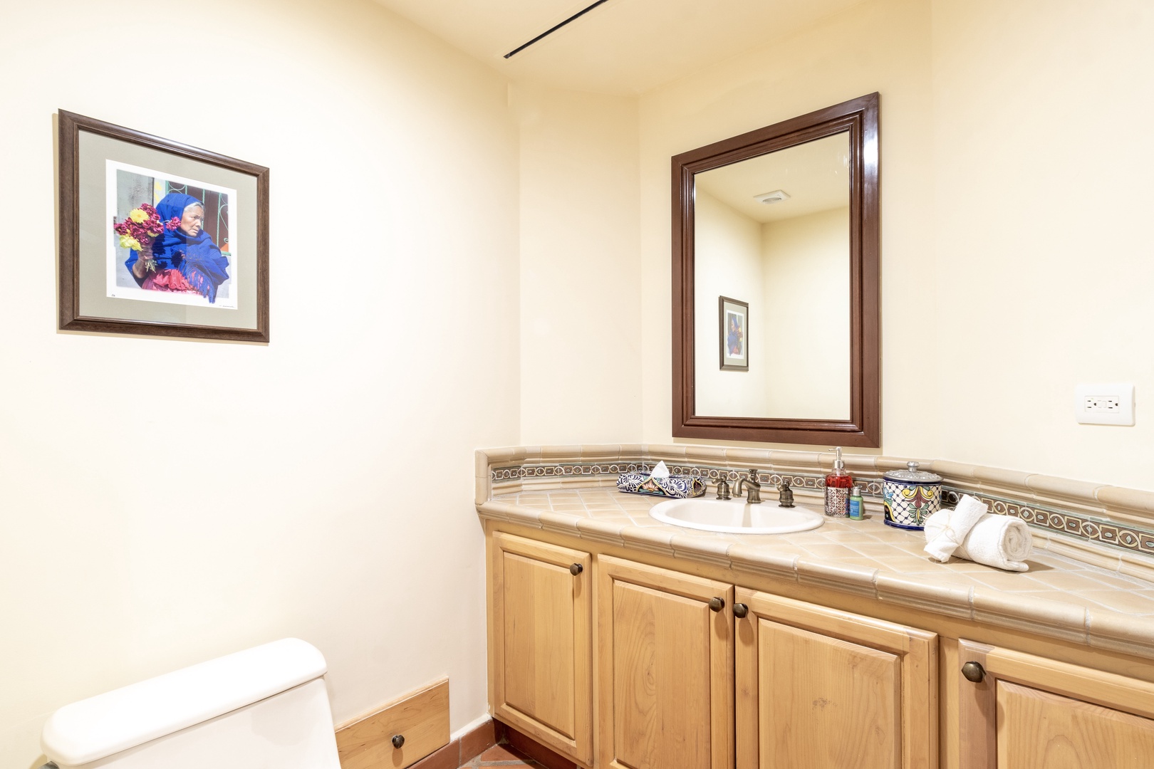 Your private bathroom features a spacious vanity with tile countertop, fresh towels, and all the essentials for a comfortable stay.