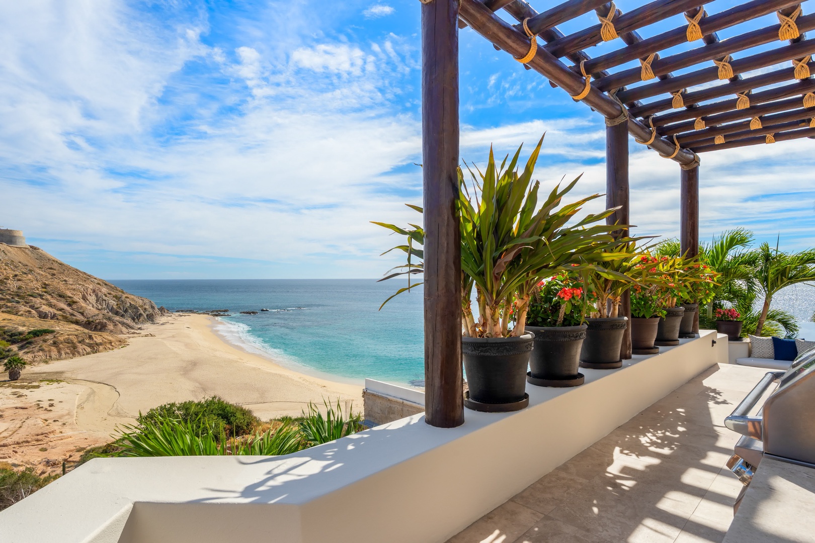 Your private terrace overlooks pristine turquoise waters and golden sand, where tropical plants create your perfect beachfront sanctuary.