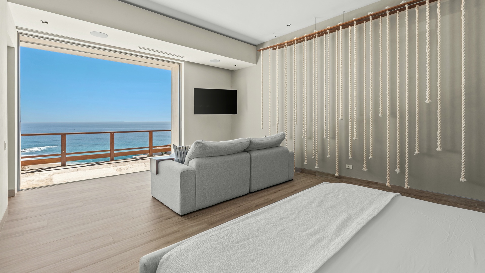 Wake up to breathtaking ocean views from your spacious room, where a plush sofa invites you to relax and the private balcony beckons for morning coffee by the sea.