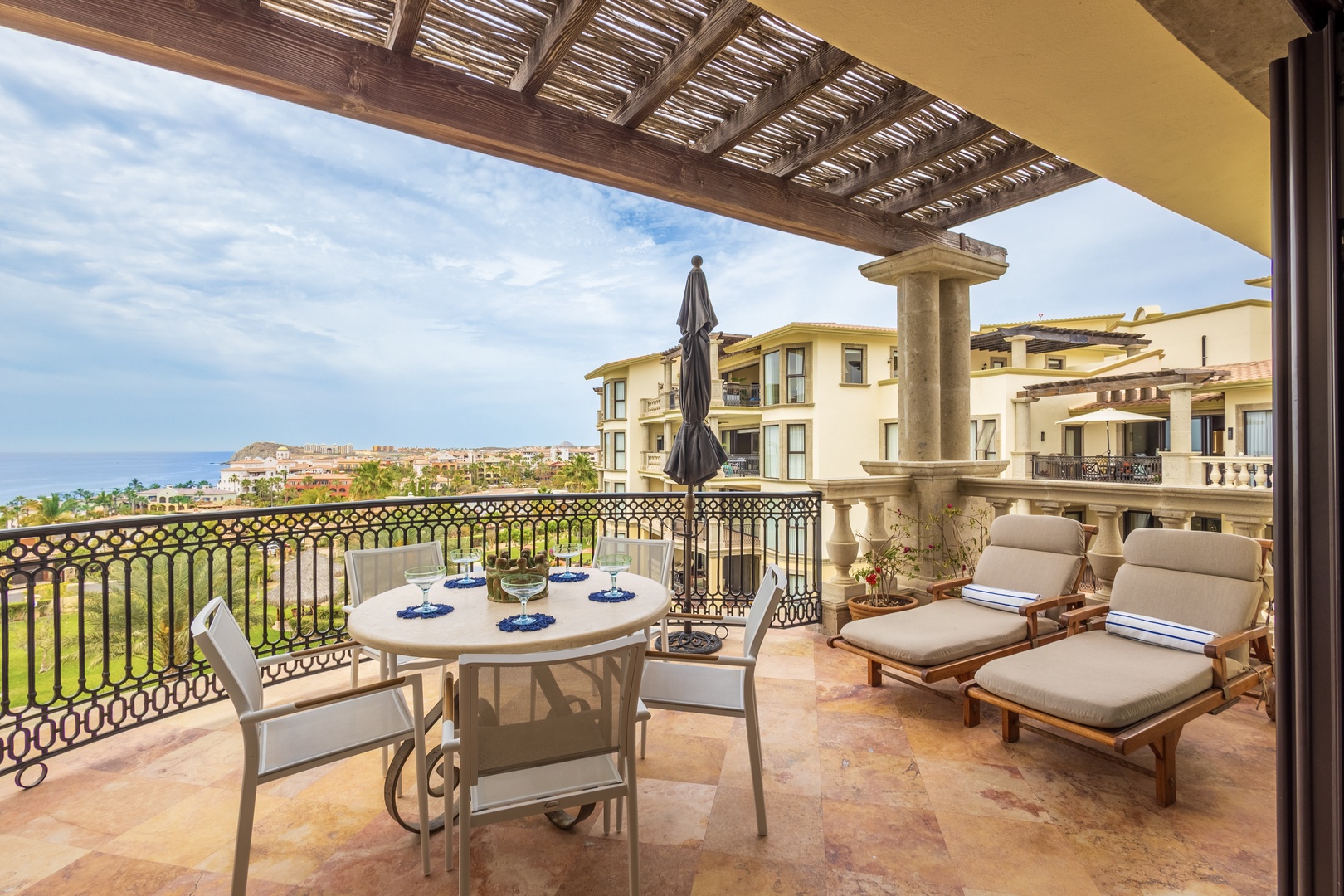Sip your morning coffee on this stunning terrace while taking in sweeping ocean views and elegant resort architecture.