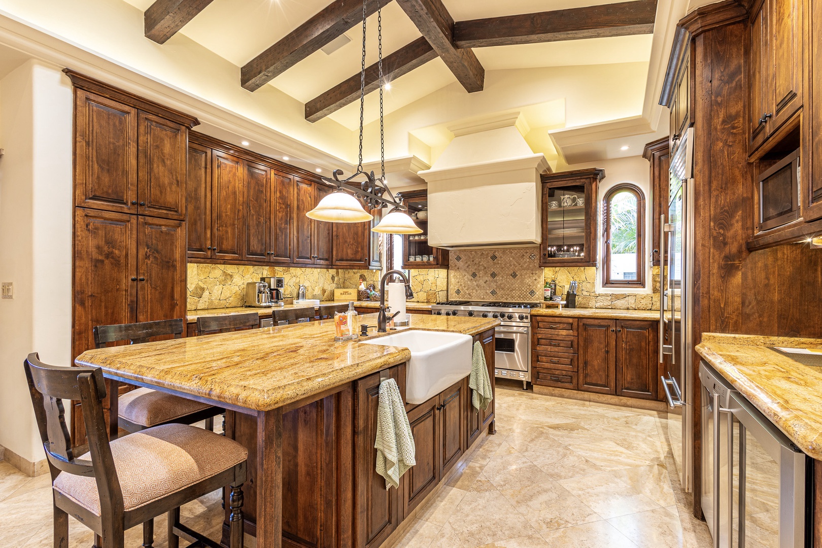 Your gourmet kitchen blends rustic charm with modern convenience—rich wood cabinetry, granite counters, and a spacious island for prepping meals or sipping morning coffee.