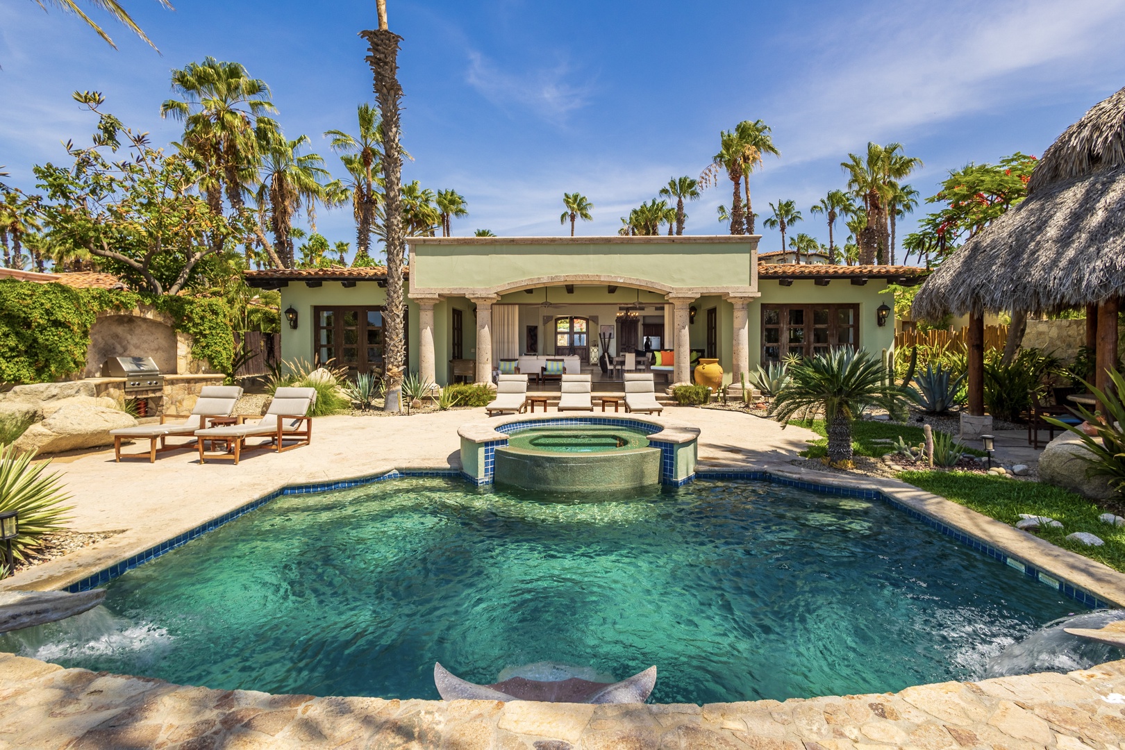 Your private oasis awaits with a sparkling pool, soothing hot tub, and loungers shaded by swaying palms. Relax poolside or unwind in the secluded garden courtyard, where desert meets tropical paradise.