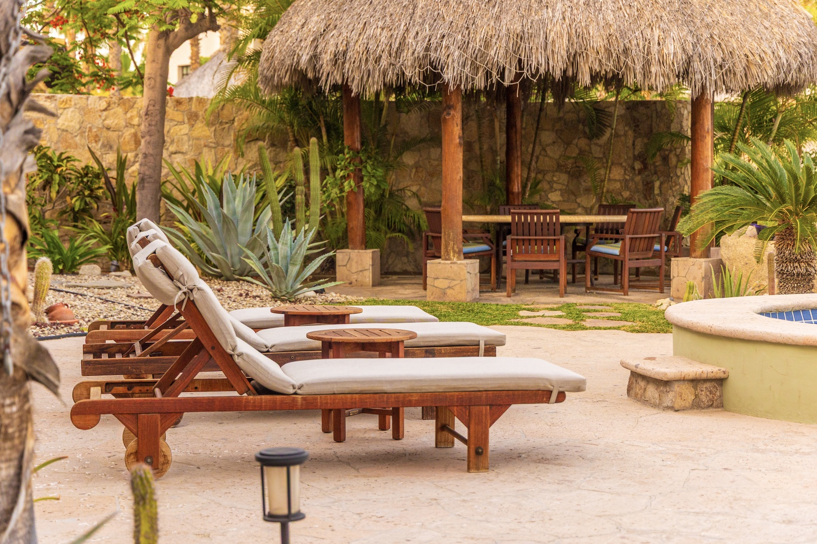 Soak up the sun on cushioned loungers by the pool, then retreat to your own thatched palapa for shade and relaxation in a lush tropical garden setting.