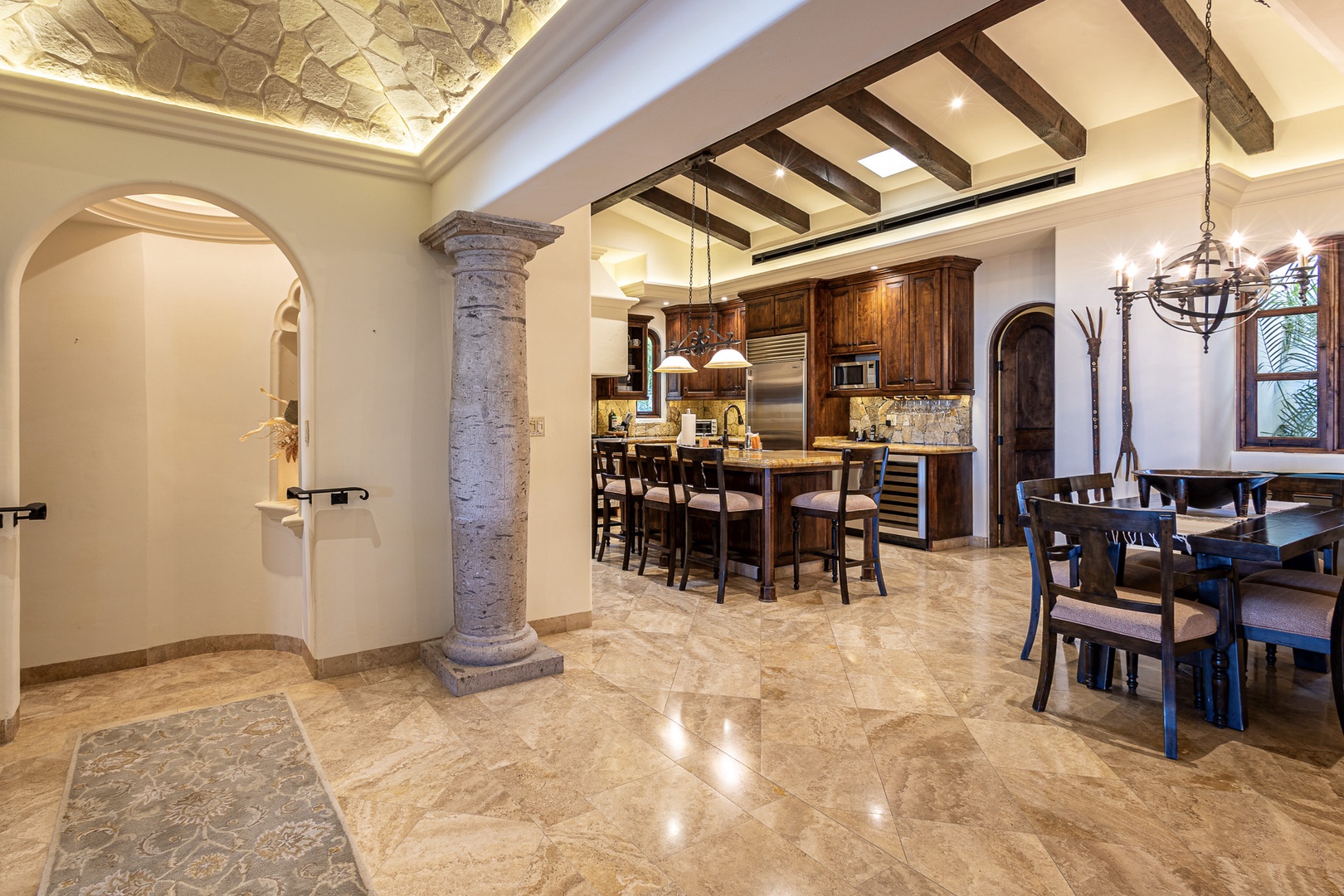 Picture yourself in this stunning open-concept space where rustic elegance meets modern comfort. Rich wood beams, stone accents, and arched doorways create a warm, inviting atmosphere for your perfect getaway.