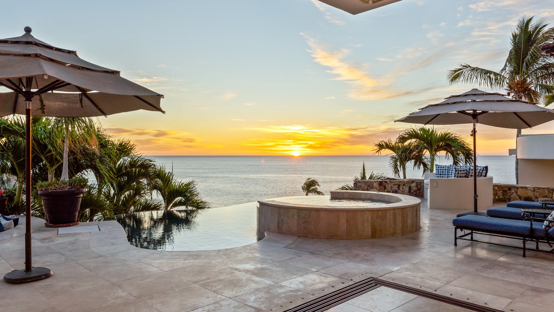 Stunning oceanfront terrace with infinity pool and hot tub where you'll watch breathtaking sunsets paint the sky in golden hues.