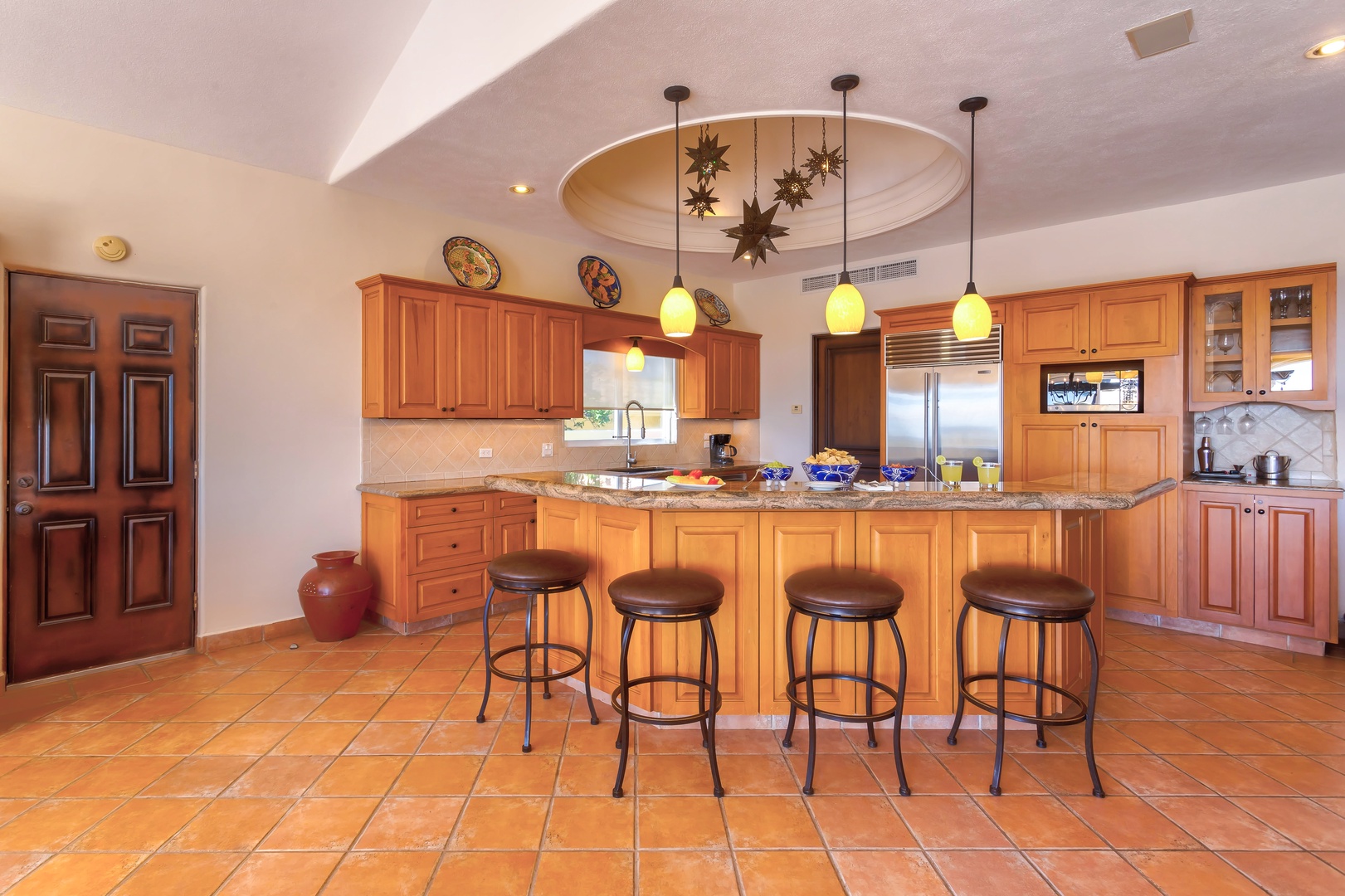 Your gourmet kitchen awaits with warm wood cabinetry, granite counters, and a welcoming island perfect for morning coffee or evening conversations.