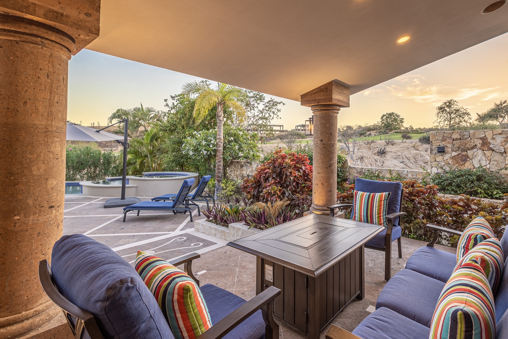 Unwind on your private covered terrace, surrounded by lush gardens and a sparkling hot tub—your peaceful retreat awaits.