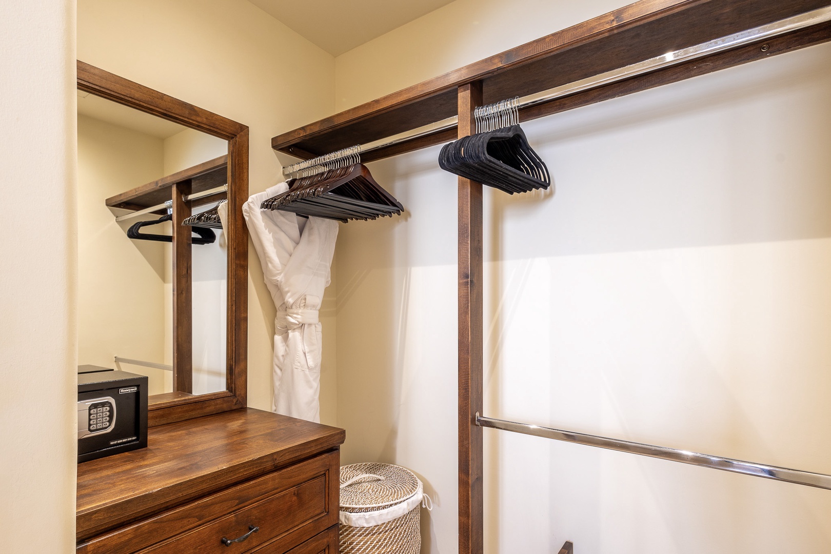 Keep your wardrobe organized in this thoughtfully designed closet with ample hanging space and a secure safe for your valuables.