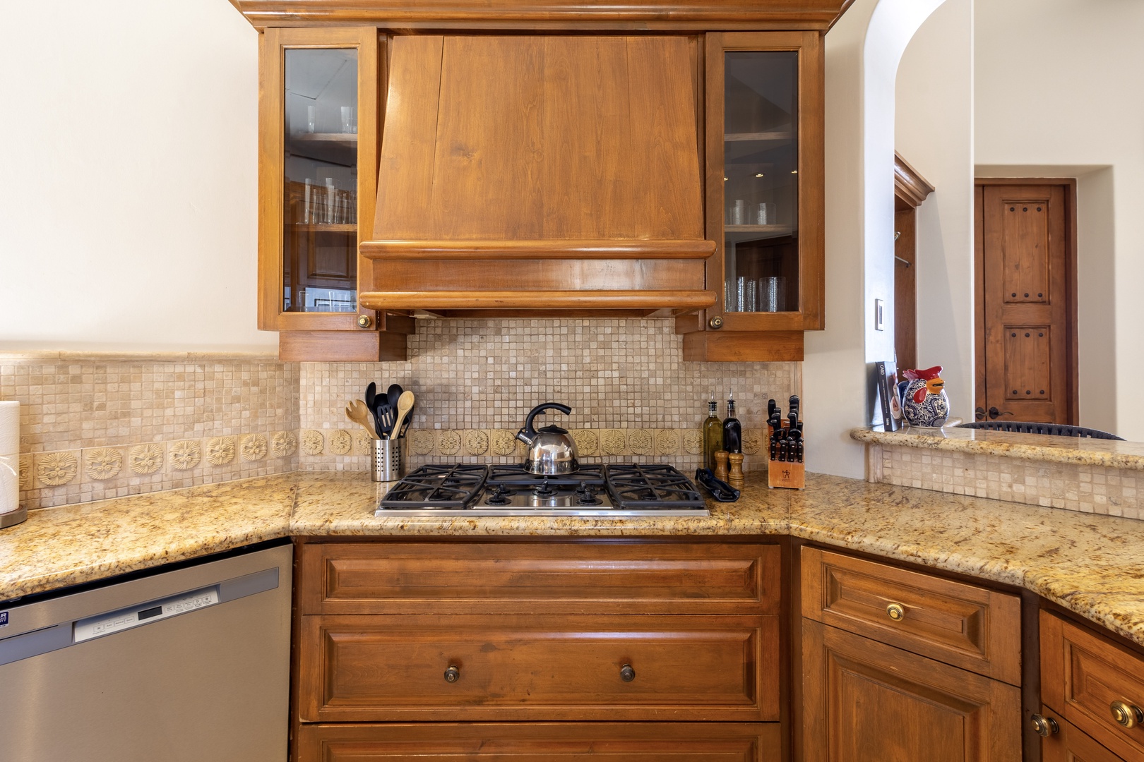 Your gourmet kitchen features rich wood cabinetry, granite counters, and gas range - perfect for preparing memorable meals during your stay.