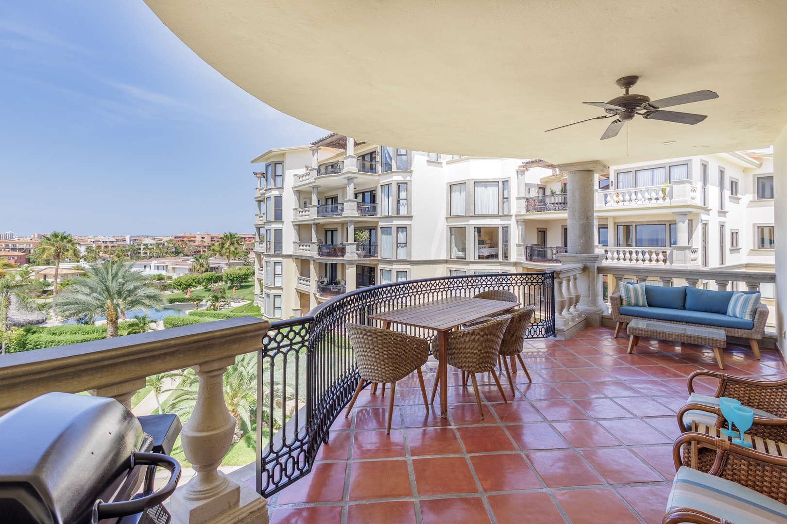 Relax on your private terrace with sweeping views of lush gardens and neighboring villas—perfect for morning coffee or evening gatherings under the fan's gentle breeze.