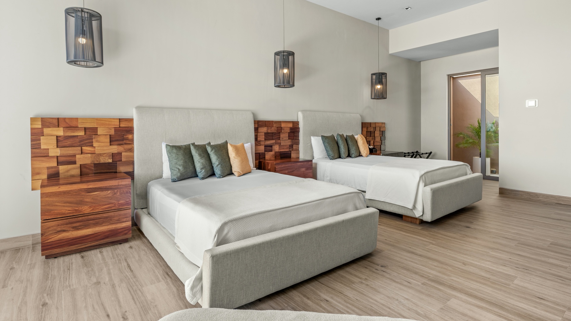 Settle into your spacious bedroom with two plush beds, modern pendant lighting, and stunning textured wood accent walls that invite a restful night's sleep.