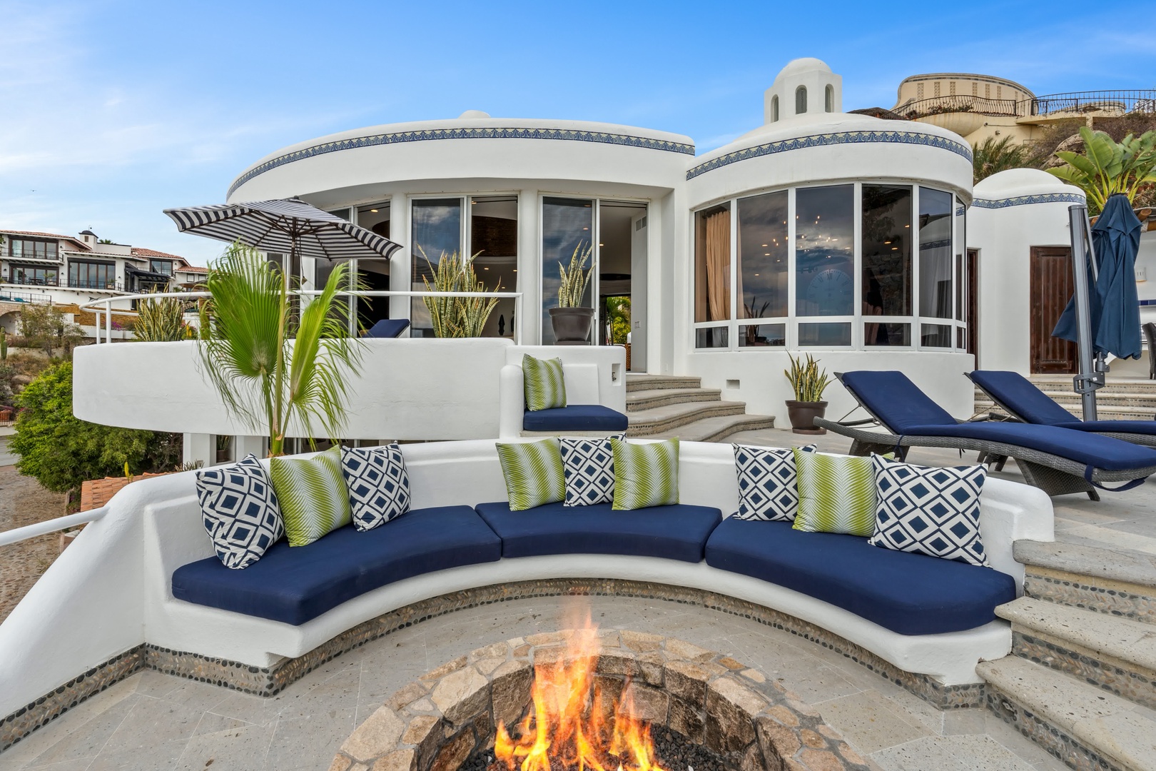 Gather around your private fire pit with plush curved seating, where flickering flames create the perfect ambiance for evening conversations under the stars.