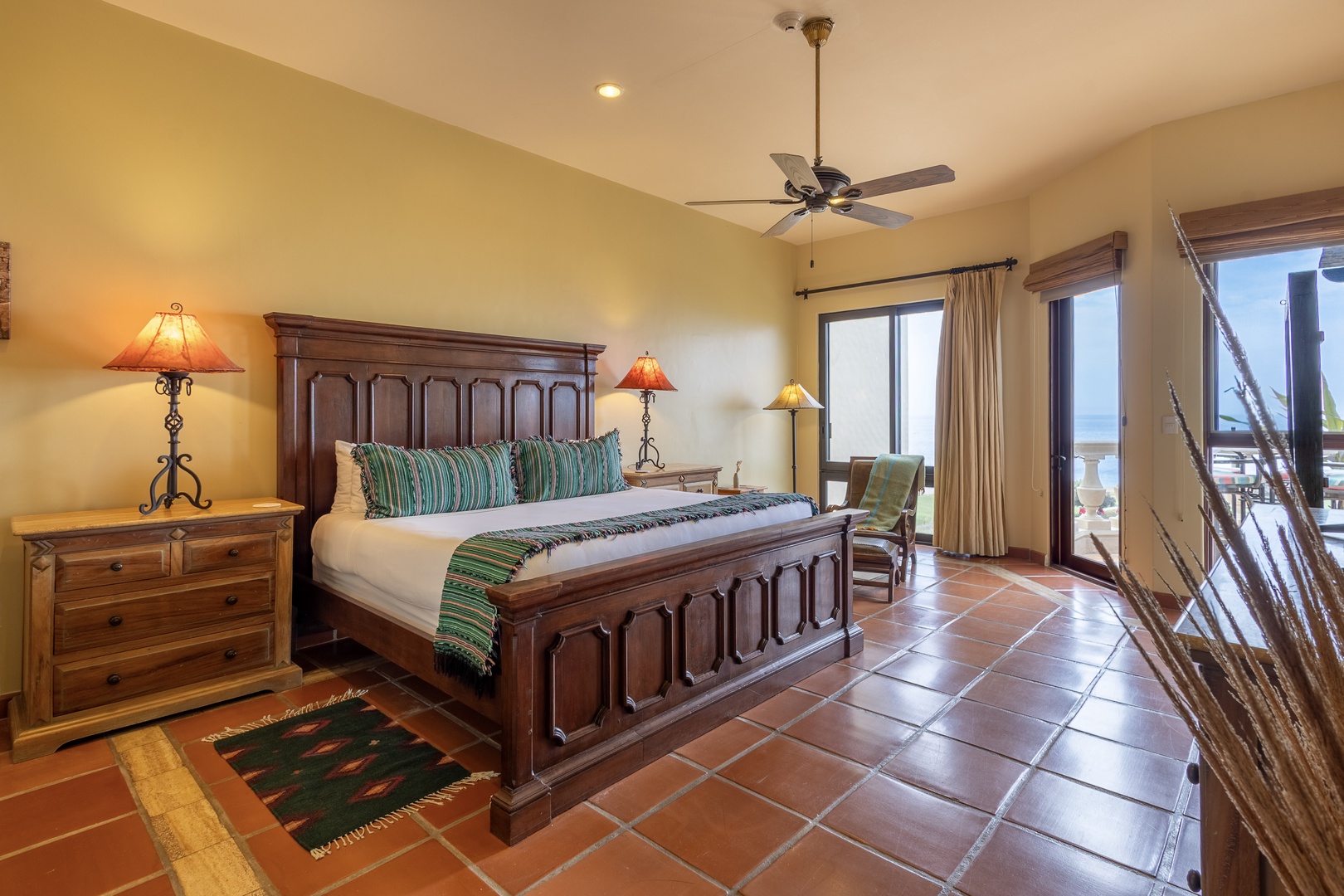 Step into your tranquil bedroom retreat with handcrafted wood furnishings and warm terracotta tile floors. Your private balcony awaits, opening to stunning sea views that greet you each morning.