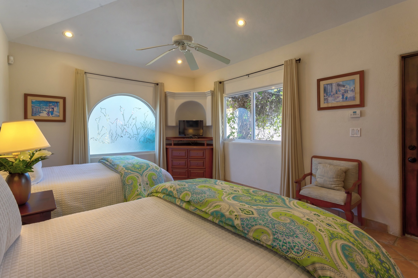 Drift off to sleep in your peaceful twin bedroom, where colorful bedding and warm lighting create the perfect retreat after exploring.