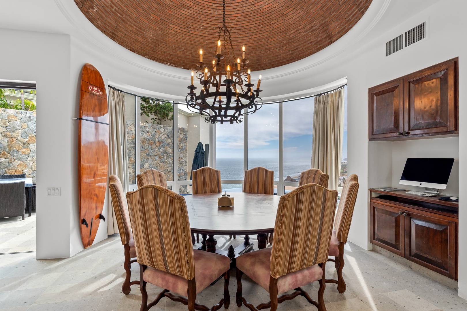 Your elegant dining room features stunning ocean views through floor-to-ceiling windows, creating the perfect backdrop for memorable meals with loved ones.