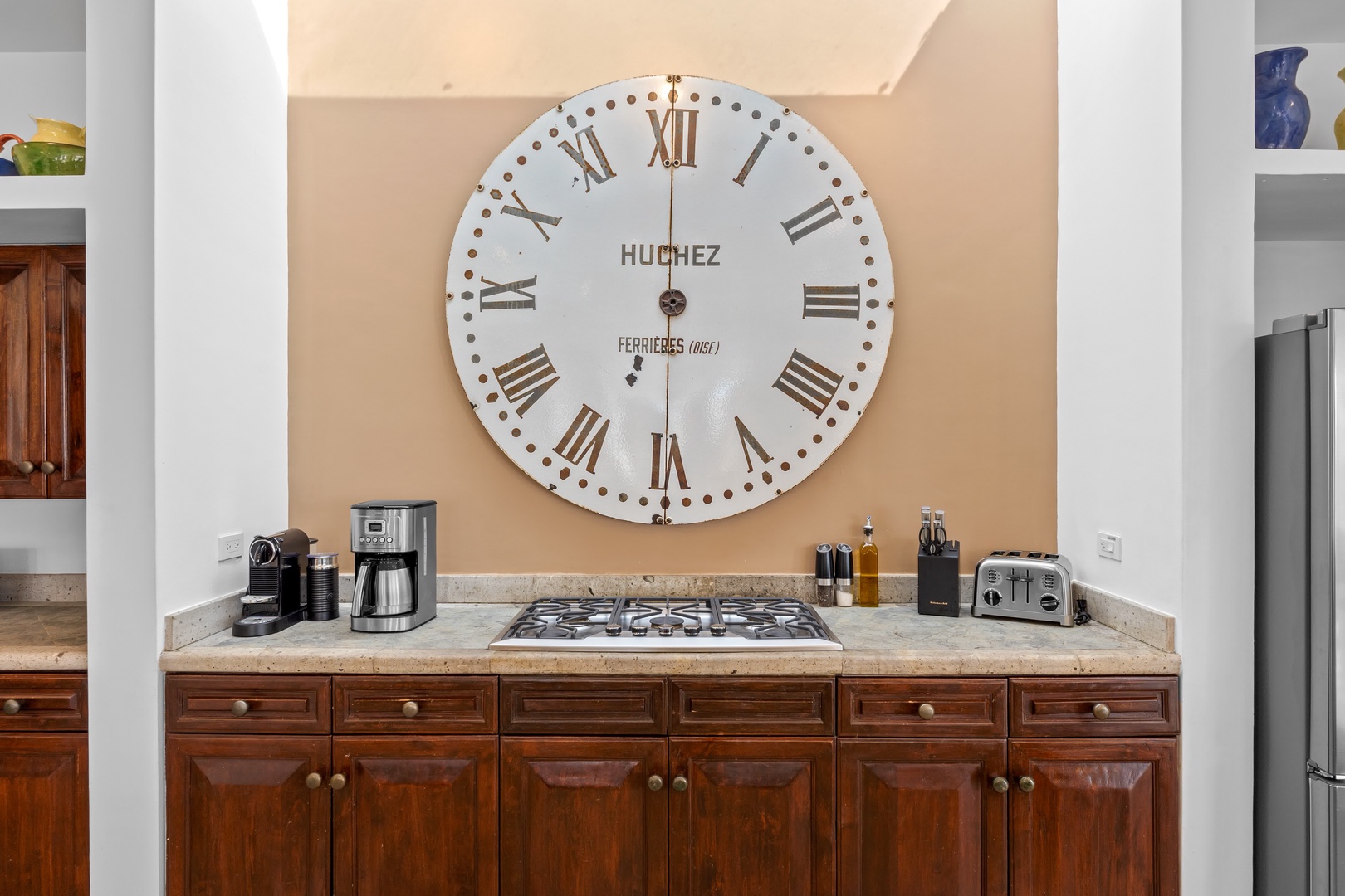 Your stylish kitchen features rich wood cabinets, granite countertops, and charming vintage clock—perfect for cooking memorable meals together.
