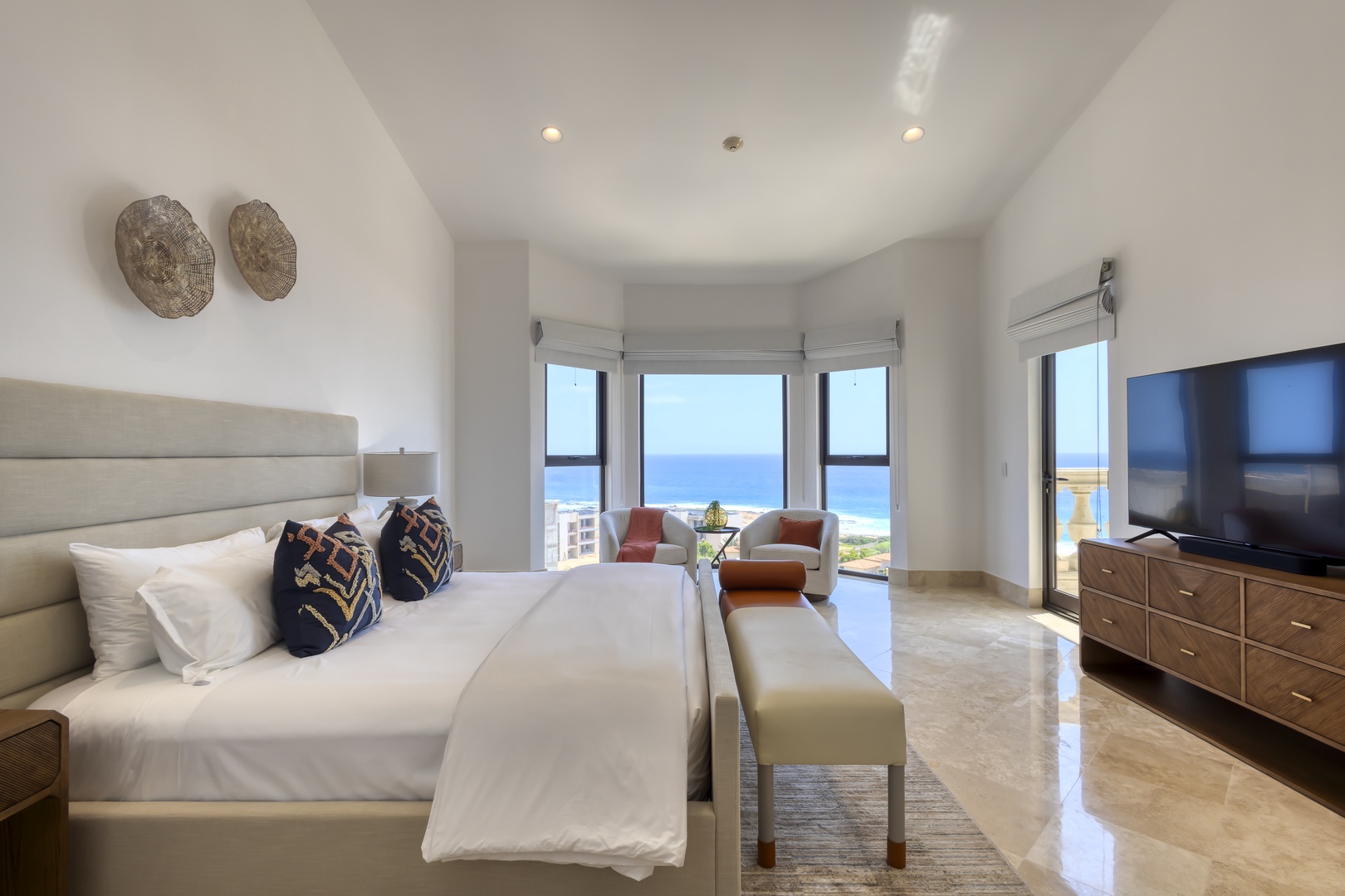 Wake up to breathtaking ocean views framed by floor-to-ceiling windows. Your spacious bedroom features a plush king bed, cozy seating, and private balcony access for morning coffee by the sea.