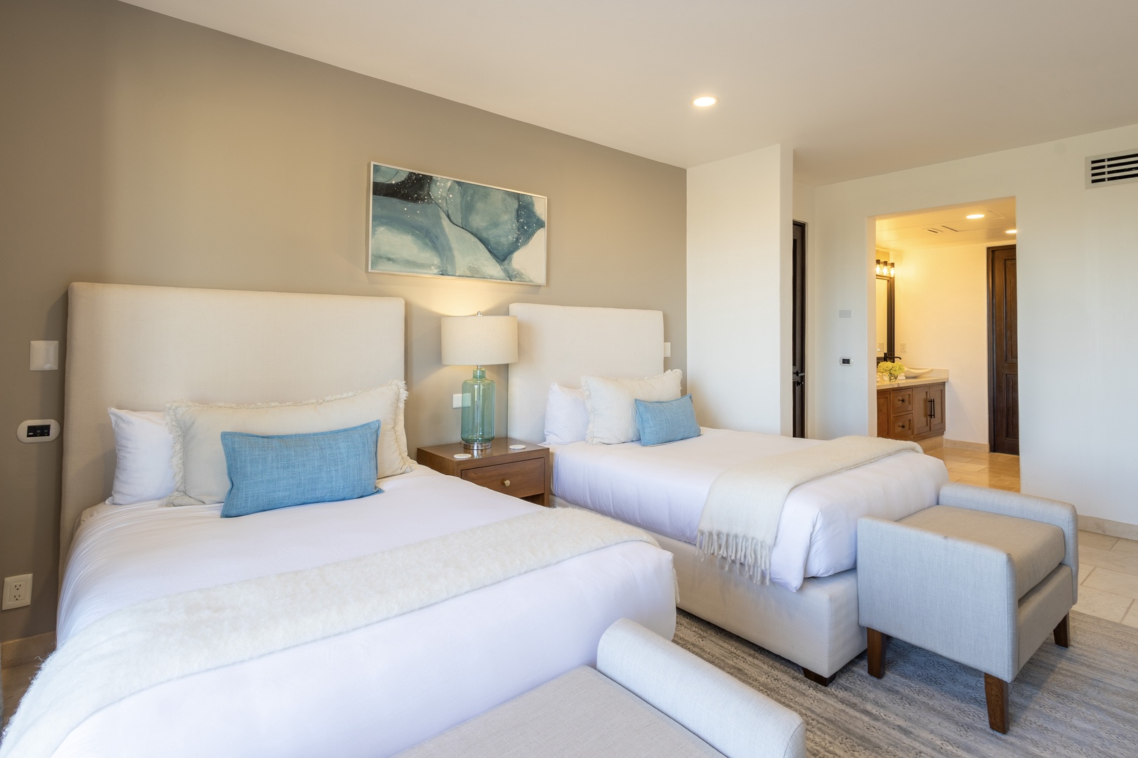 Sink into soft linens and coastal calm with two cozy beds, soothing blue accents, and your private ensuite just steps away. Perfect for unwinding after a day in the sun.