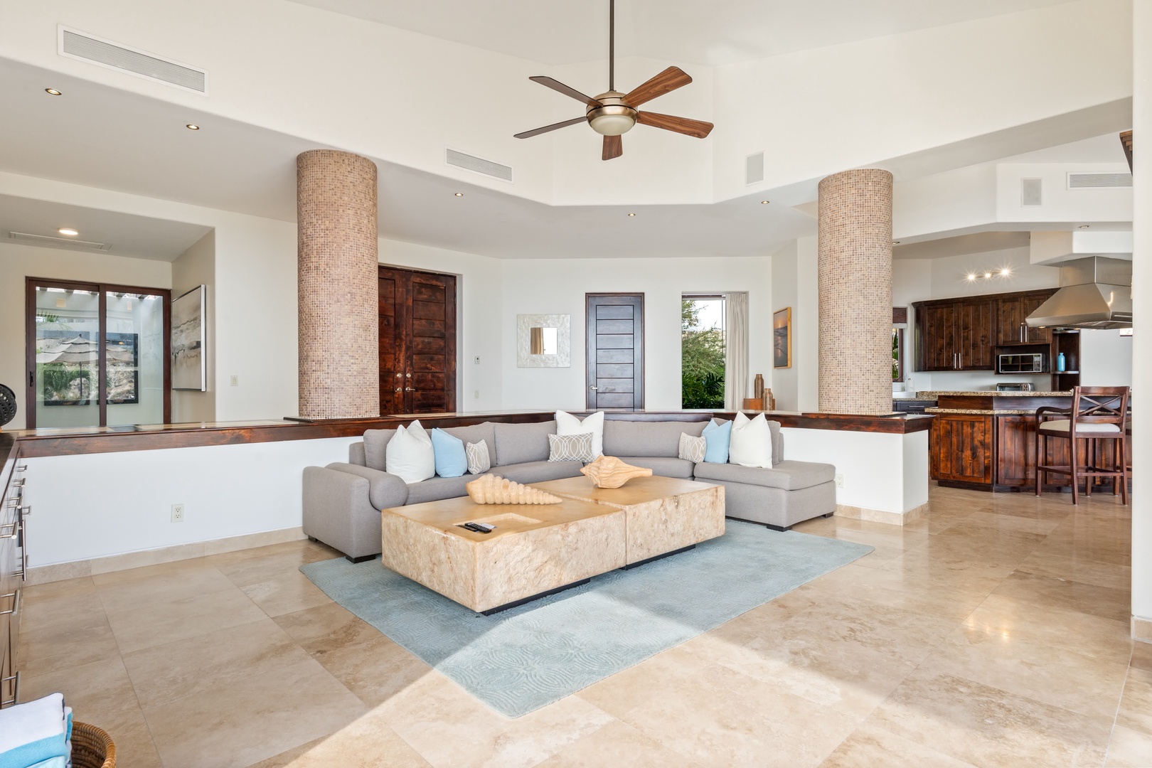 Relax in your spacious open-concept living area with soaring ceilings, modern furnishings, and seamless flow to the gourmet kitchen.