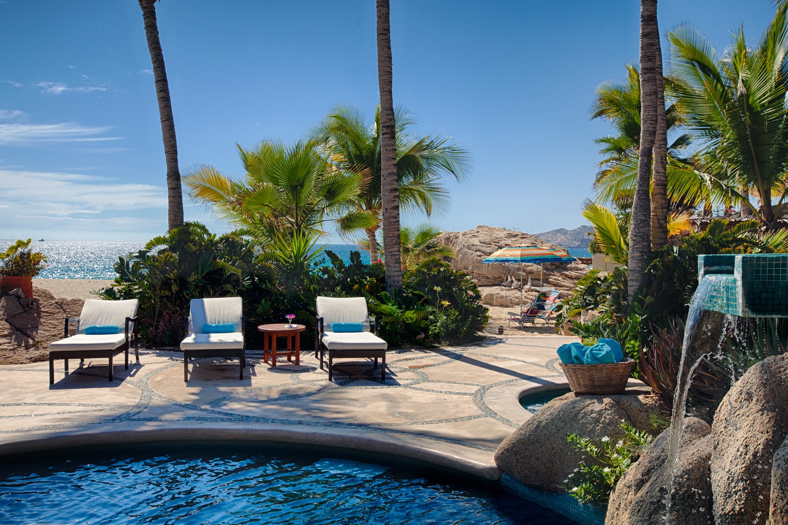 Soak up paradise beside your private pool, where swaying palms frame ocean views and comfortable loungers await your relaxation.