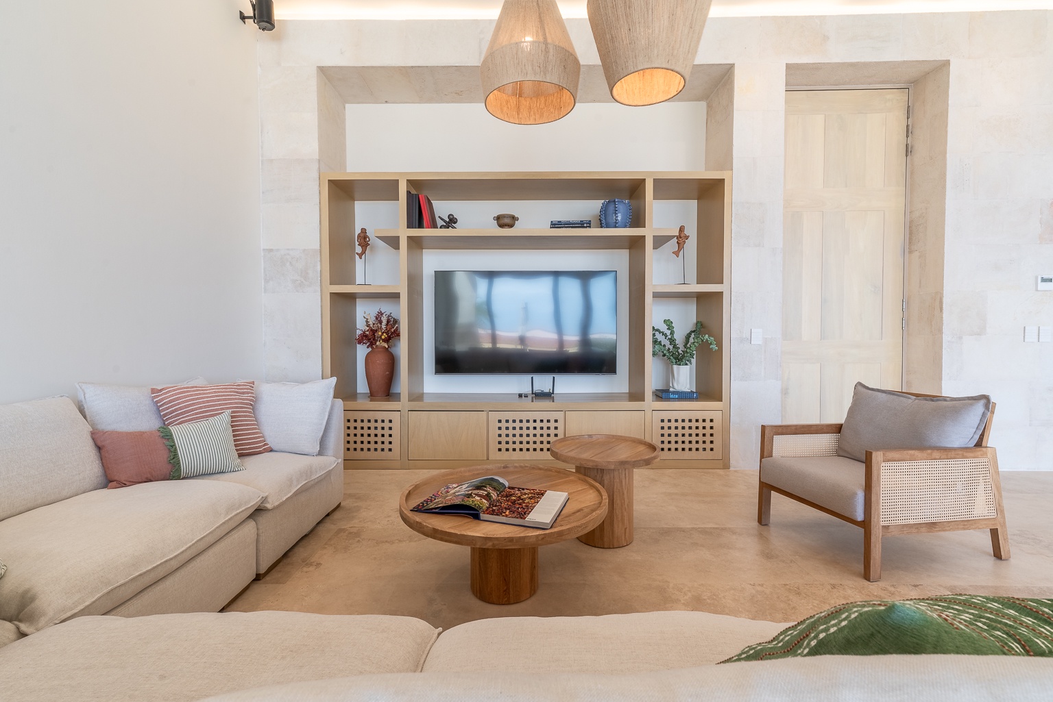 Unwind in your elegant living space with custom shelving, plush seating, and a large flatscreen—perfect for cozy evenings after exploring all day.