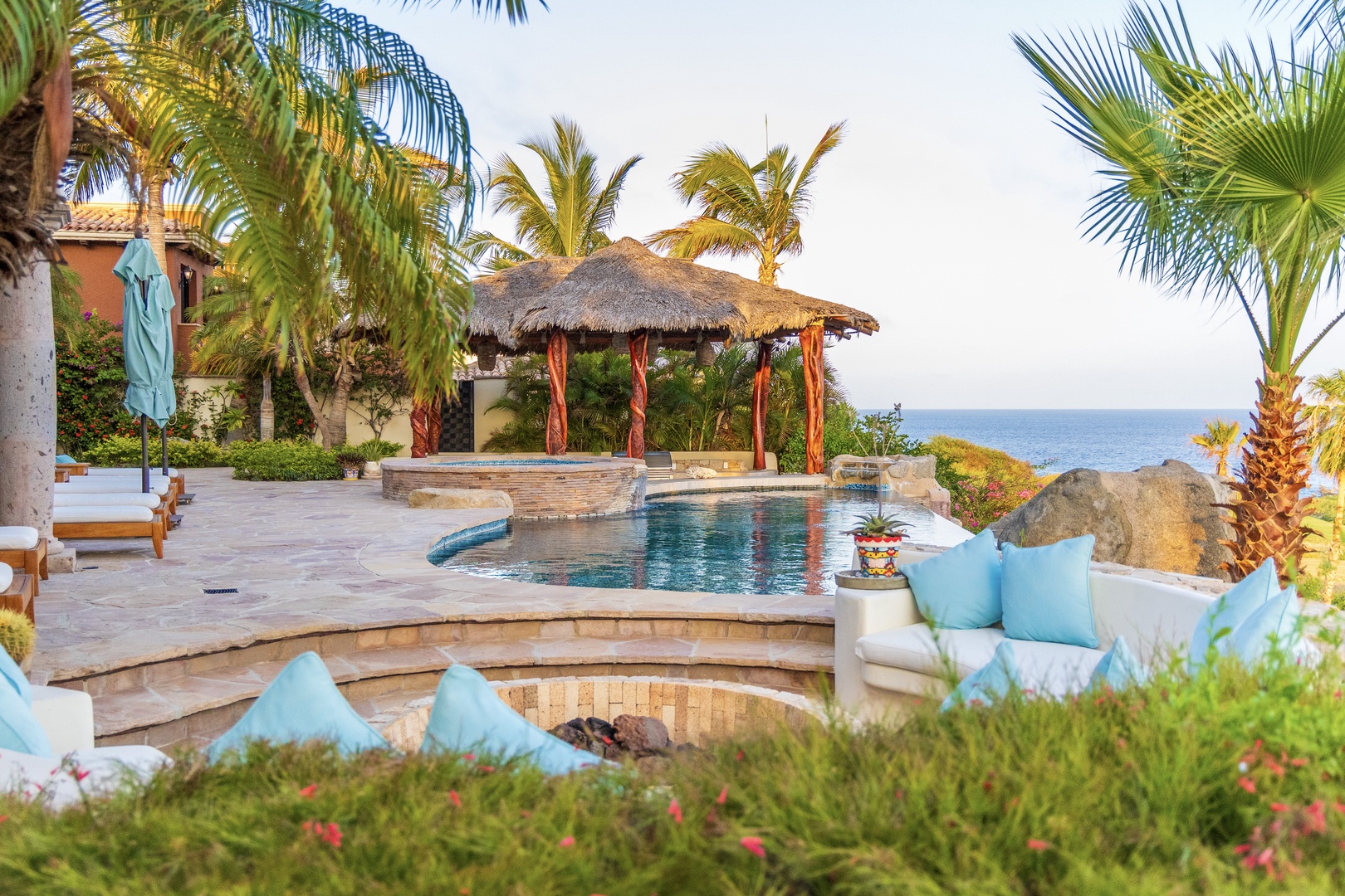 Your private paradise awaits with a sparkling pool, palapa shade, and oceanfront seating—perfect for soaking up the sun and tropical breezes just steps from the sea.