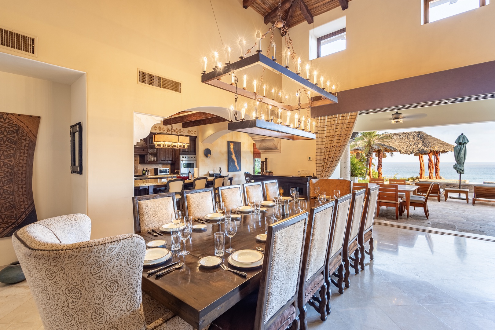 Picture yourself hosting unforgettable gatherings at this stunning dining table, where a dramatic chandelier sets the mood. Open-concept design flows seamlessly to your private beachfront palapa, merging indoor luxury with ocean views.