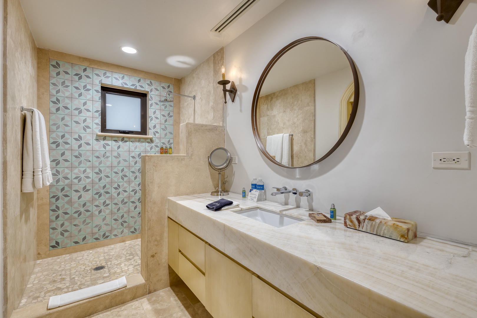 Enjoy your spacious bathroom with elegant tile work, a luxurious walk-in shower, and soft natural lighting for your complete comfort and relaxation.