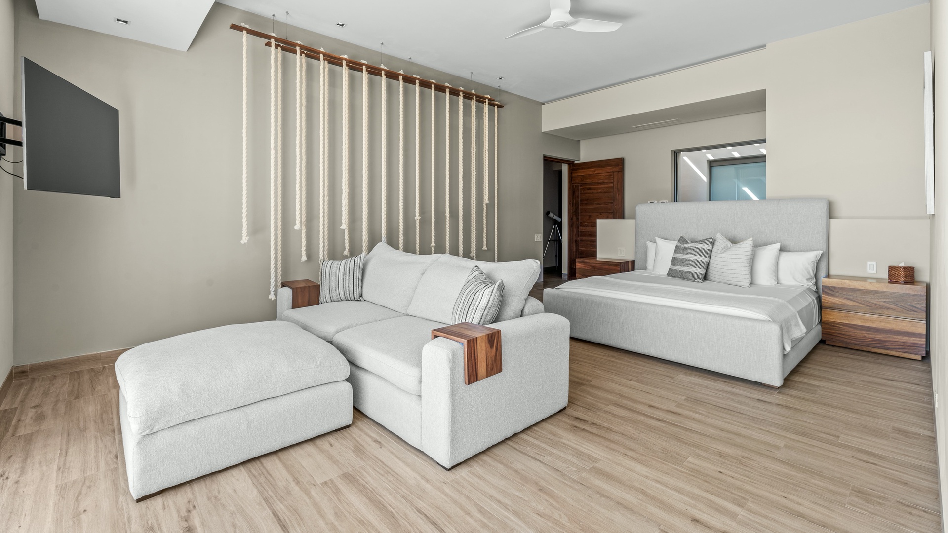 Unwind in your spacious suite, where a plush lounge and king-sized bed invite you to relax after a day of exploring. The soothing tones and modern design create your perfect private retreat.