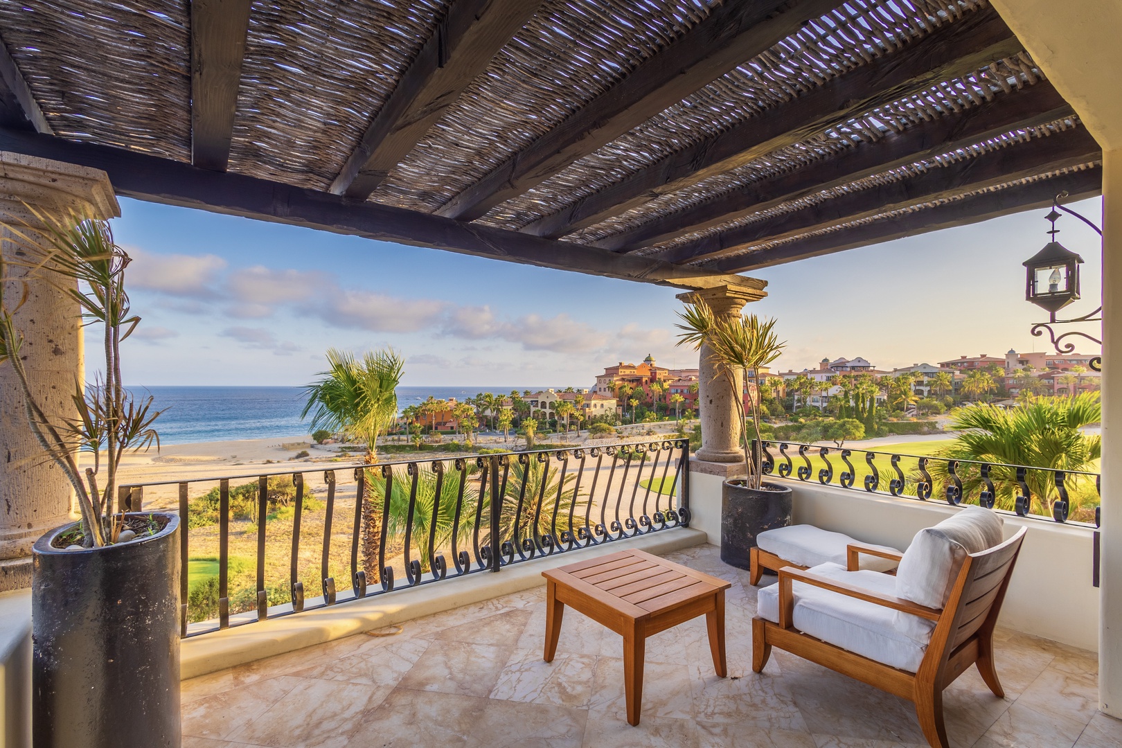 Unwind in your private terrace retreat, where plush seating frames breathtaking ocean and resort views. Let warm coastal breezes and the sound of distant waves wash over you beneath a charming thatched-beam canopy.