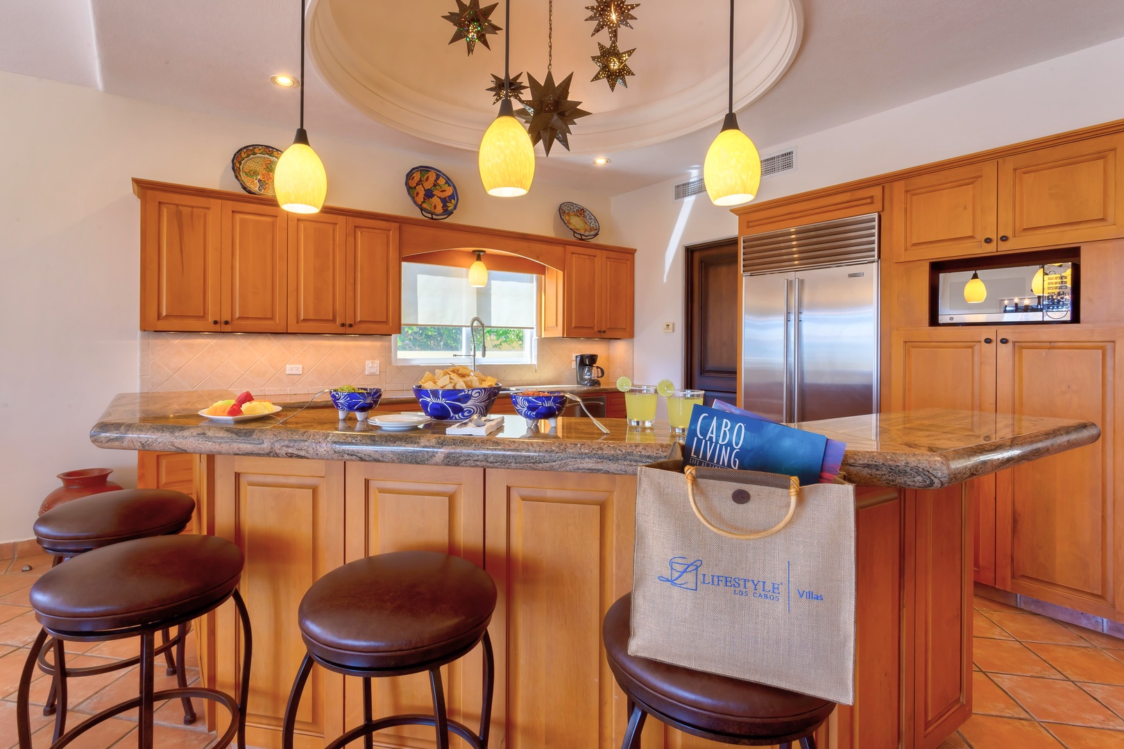 Gather around your spacious kitchen island with granite counters, warm wood cabinets, and charming pendant lighting for memorable meal prep.