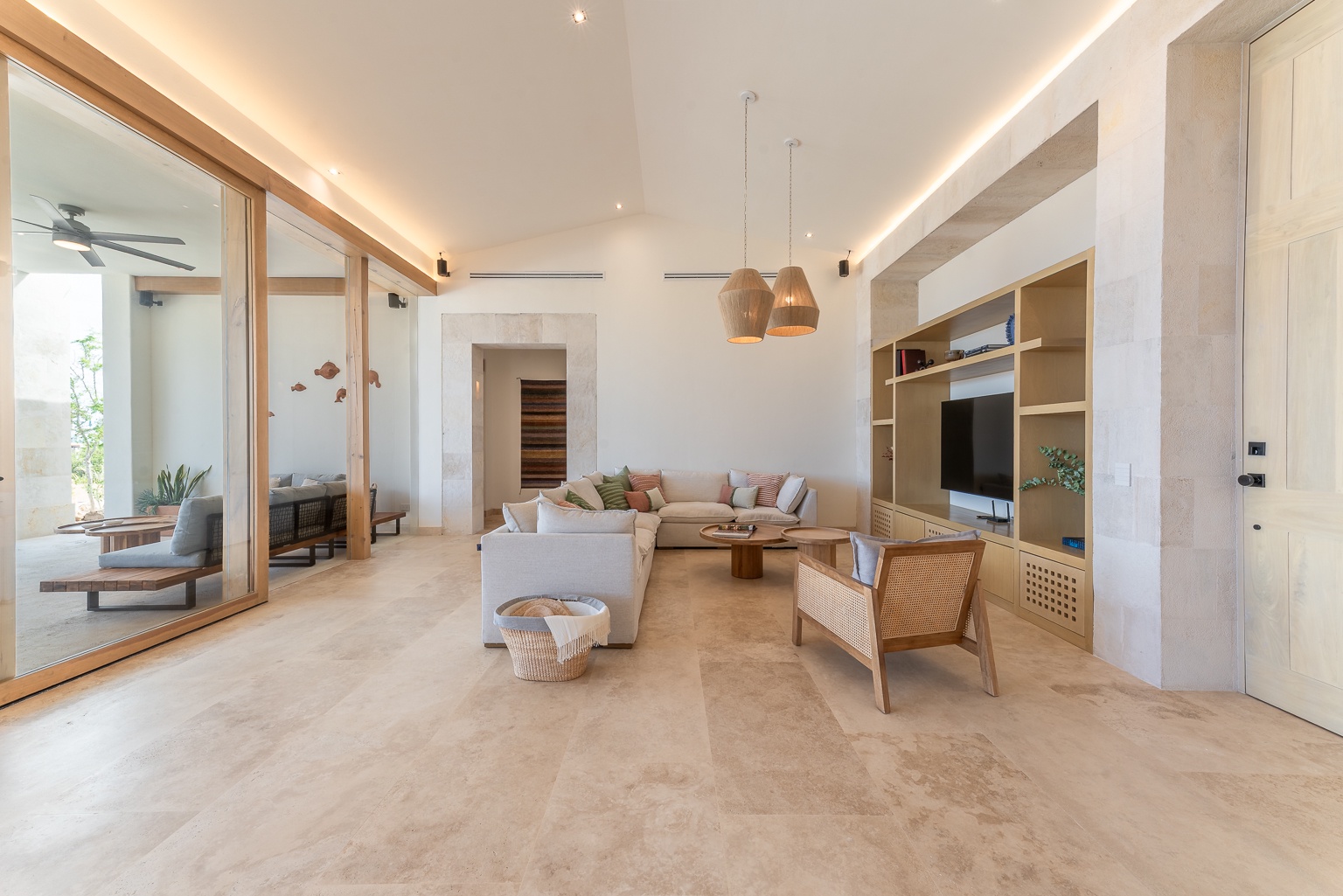 Sink into plush seating in your open-plan living room, where warm wood accents and soft lighting create a serene retreat perfect for unwinding after a day of adventure.