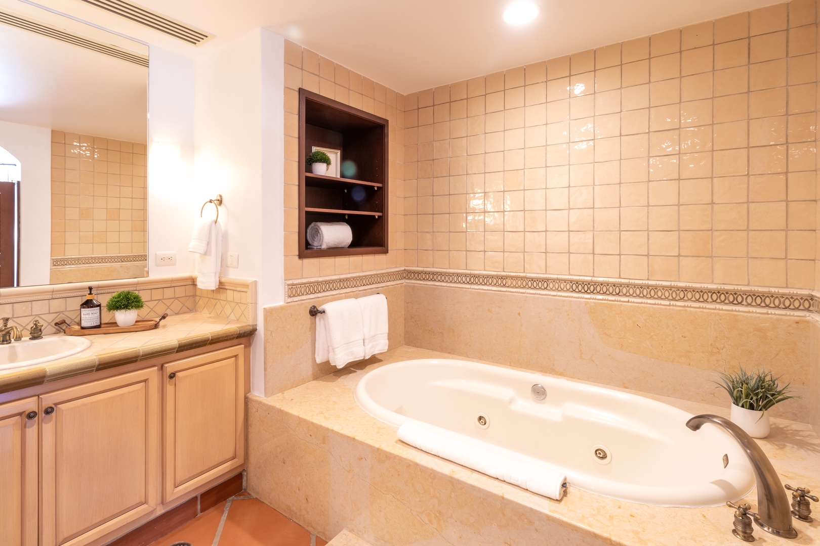 Sink into your private jetted tub surrounded by warm tile and soft lighting—your personal sanctuary awaits after a day of adventure.