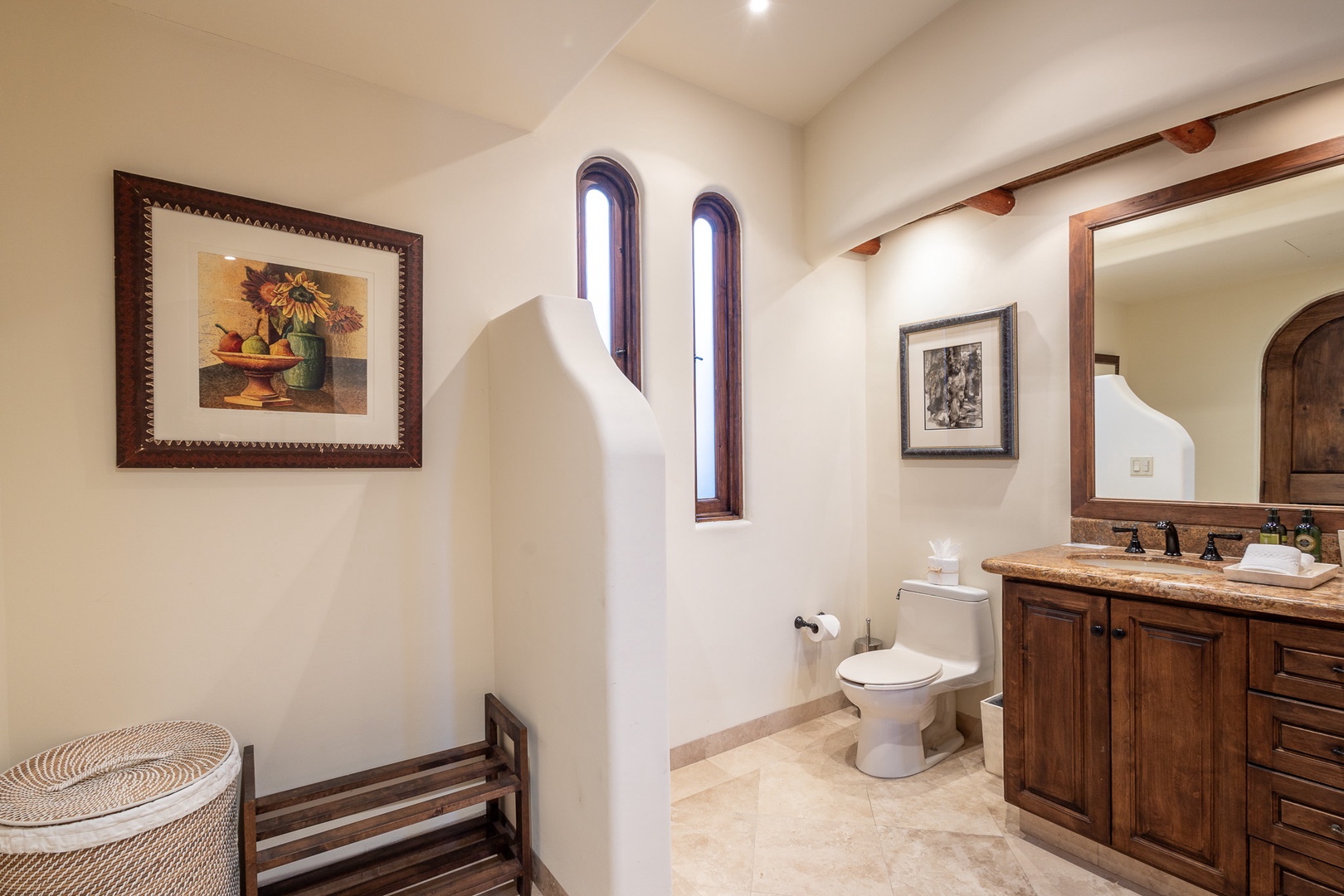 Freshen up in your private bathroom, where rustic charm meets modern comfort with elegant stonework and warm wood details.