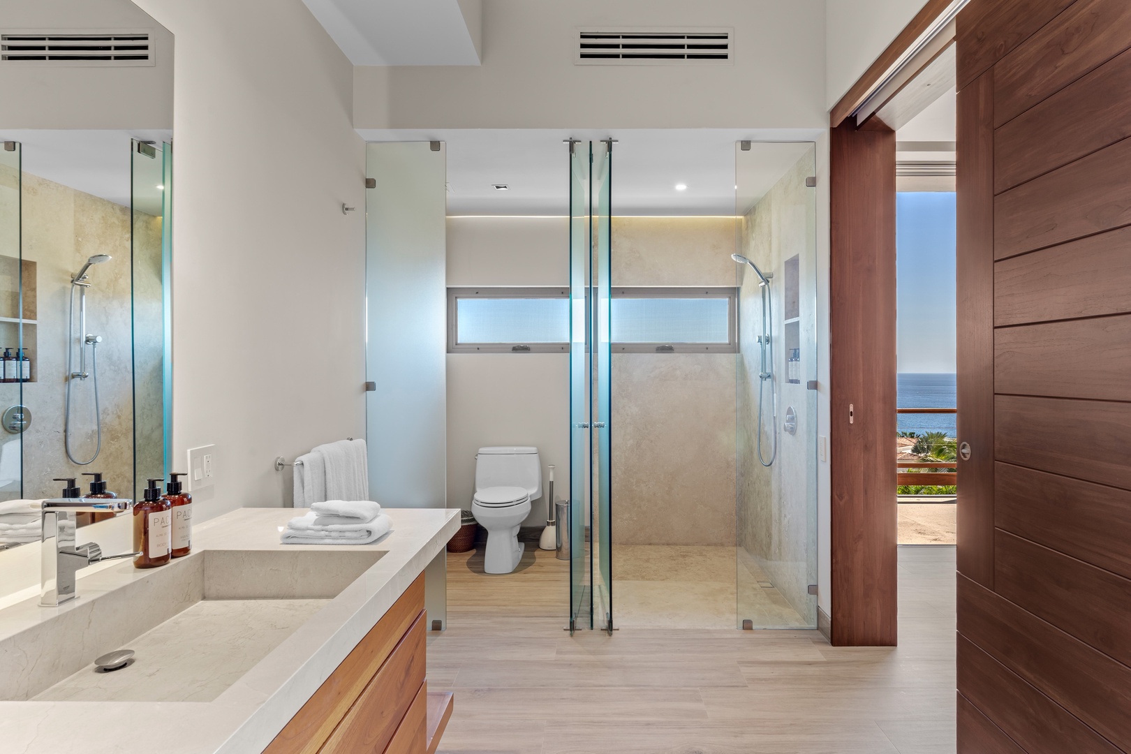 Step into your private spa-like retreat with dual rainfall showers, sleek modern finishes, and calming ocean views that create the perfect space to unwind after a day of adventure.