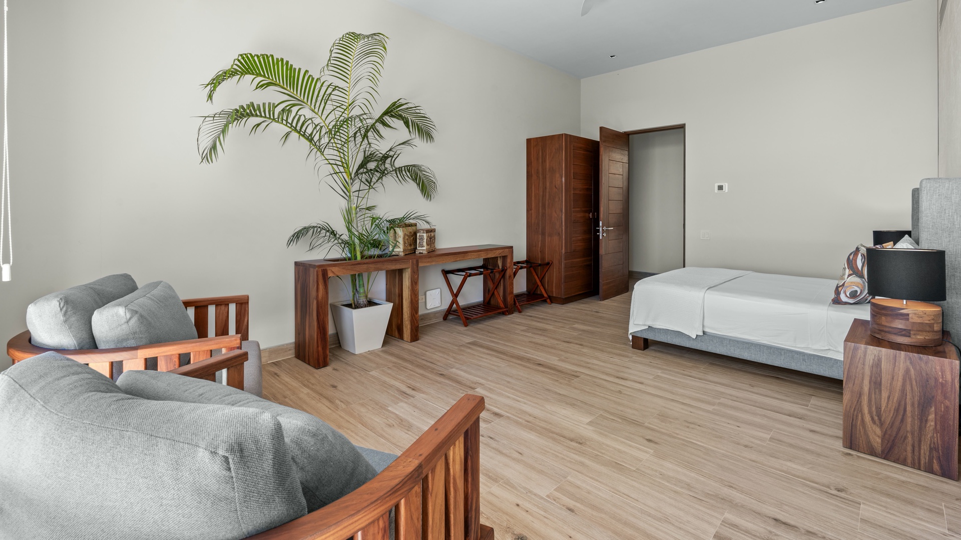 Unwind in your spacious retreat with warm wood tones, plush seating, and natural light. A peaceful blend of comfort and style awaits your arrival.