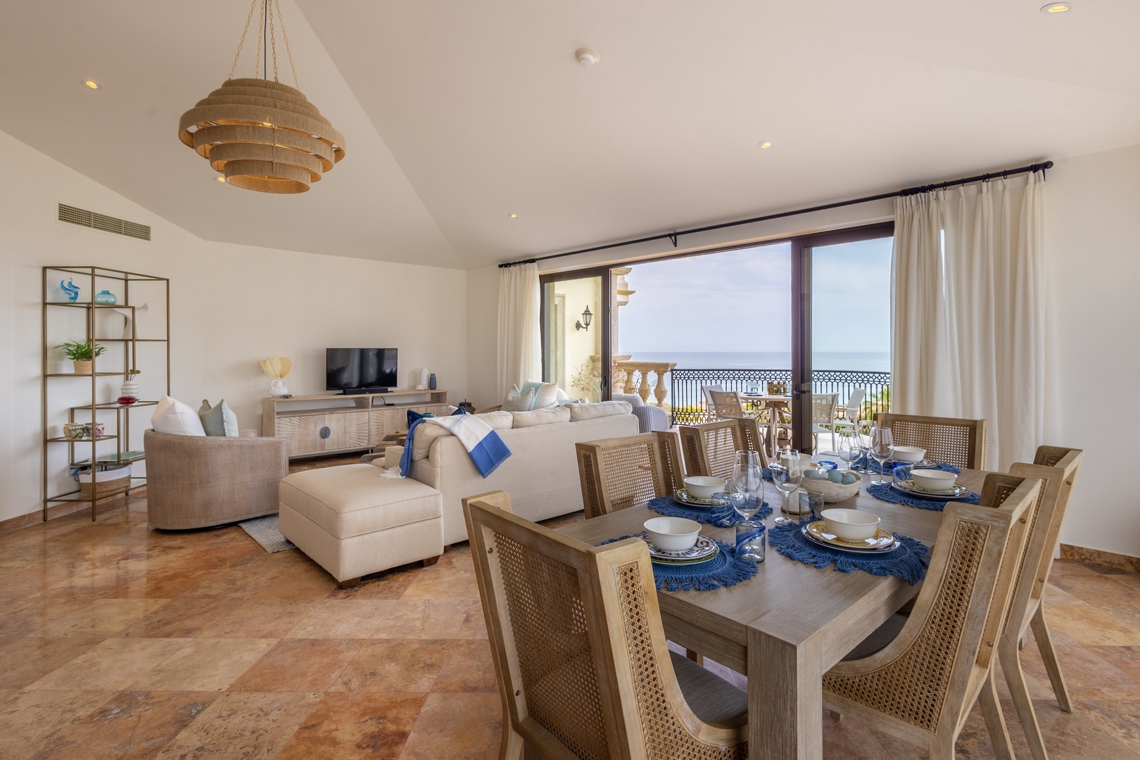 Relax in your elegant living space with stunning ocean views through floor-to-ceiling windows and enjoy memorable meals at your dining table.