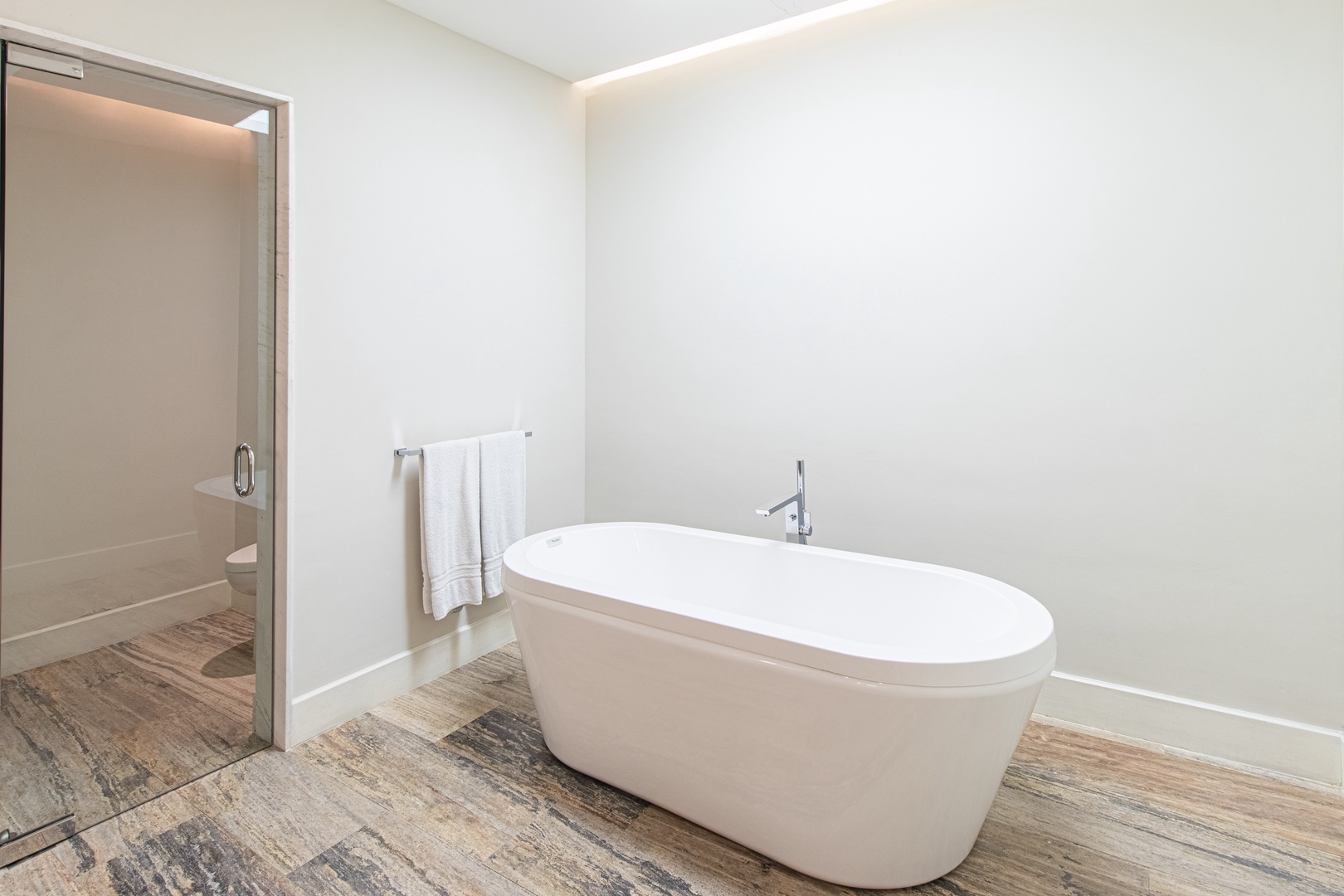 Your private sanctuary awaits: slip into this elegant freestanding soaking tub and let the stresses of the day melt away in serene, modern comfort.