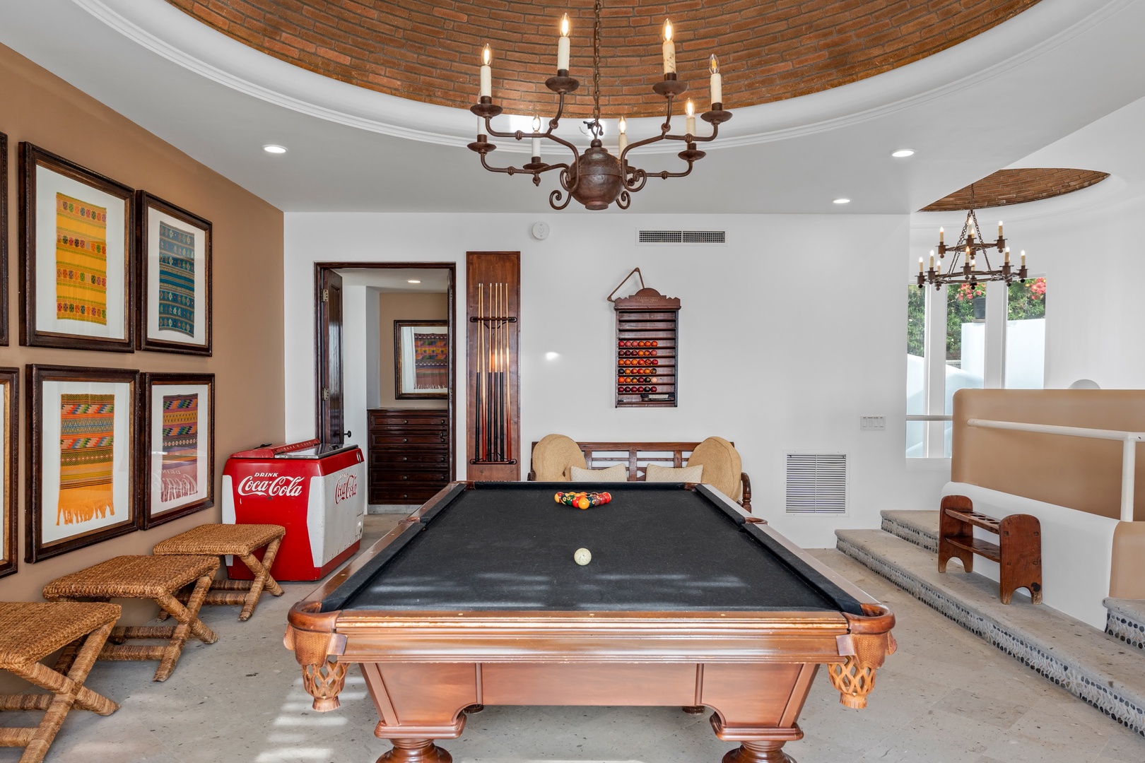 Your game room awaits with pool table, vintage Coca-Cola cooler, and warm brick ceiling details for perfect entertainment.