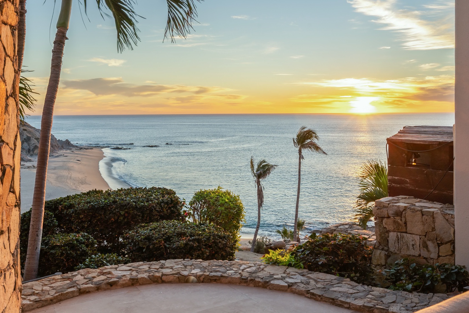 Stunning oceanfront property showcases pristine beach access and breathtaking sunset views over tropical paradise waters.