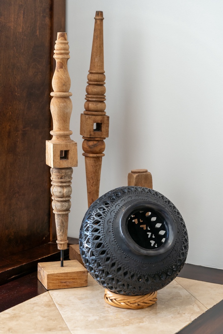 Admire these beautiful handcrafted wooden sculptures and ceramic pieces that add artistic charm to your space.