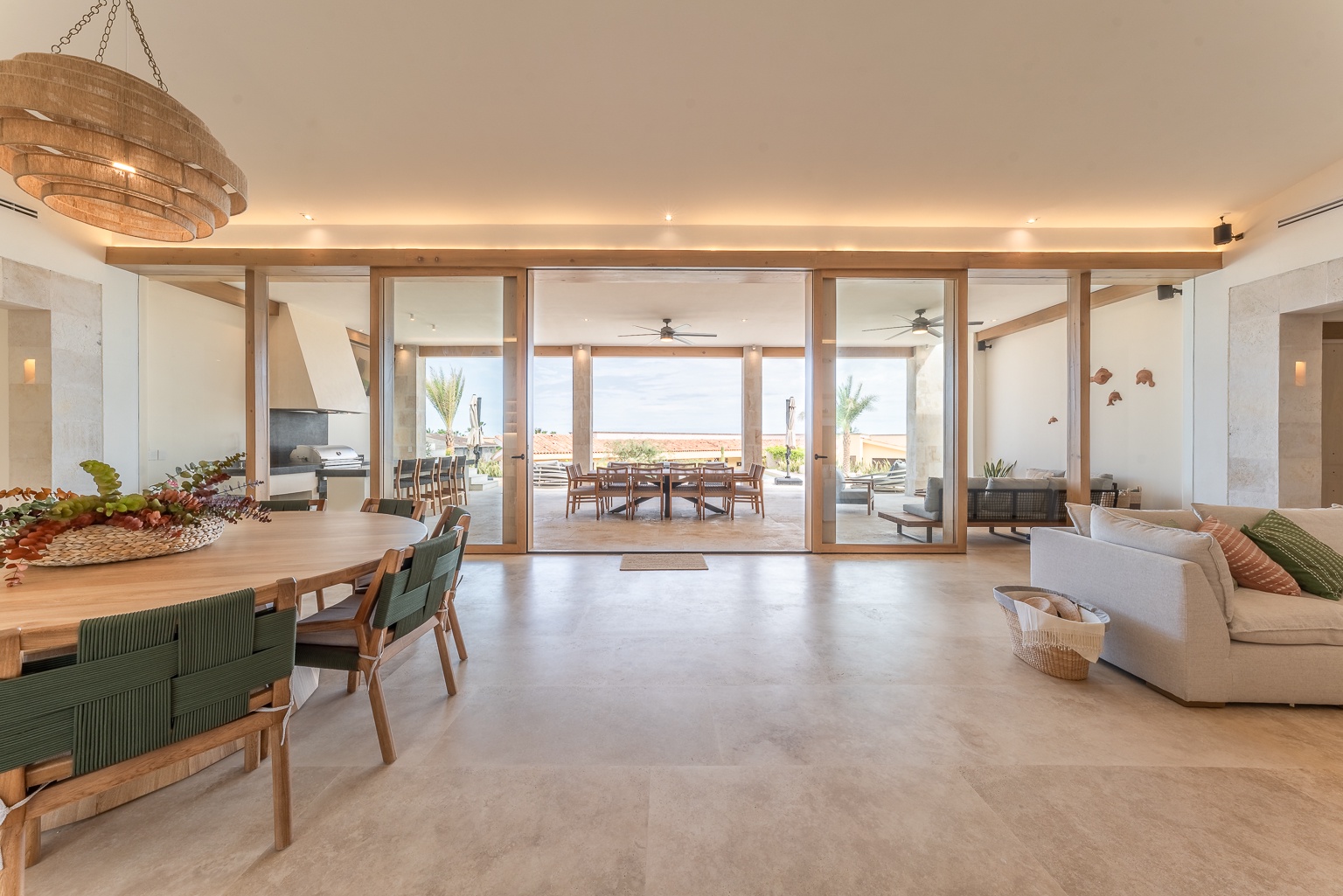 Step into your open-concept sanctuary where coastal elegance meets comfort. Natural light floods the living and dining areas, framing breathtaking ocean views through expansive glass doors that invite you onto your private outdoor terrace.