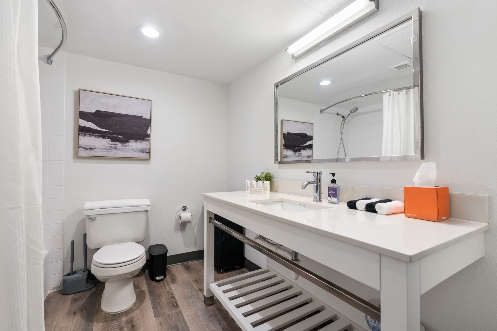 The bathroom includes towels and toiletry essentials.