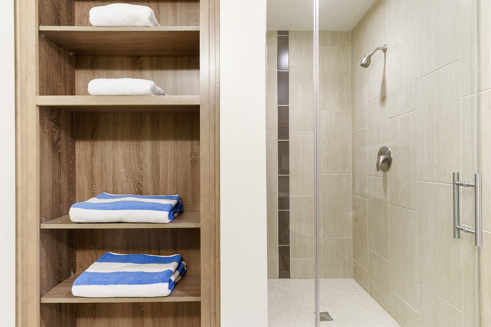 Feel invigorated in the modern walk-in shower with sleek fixtures.