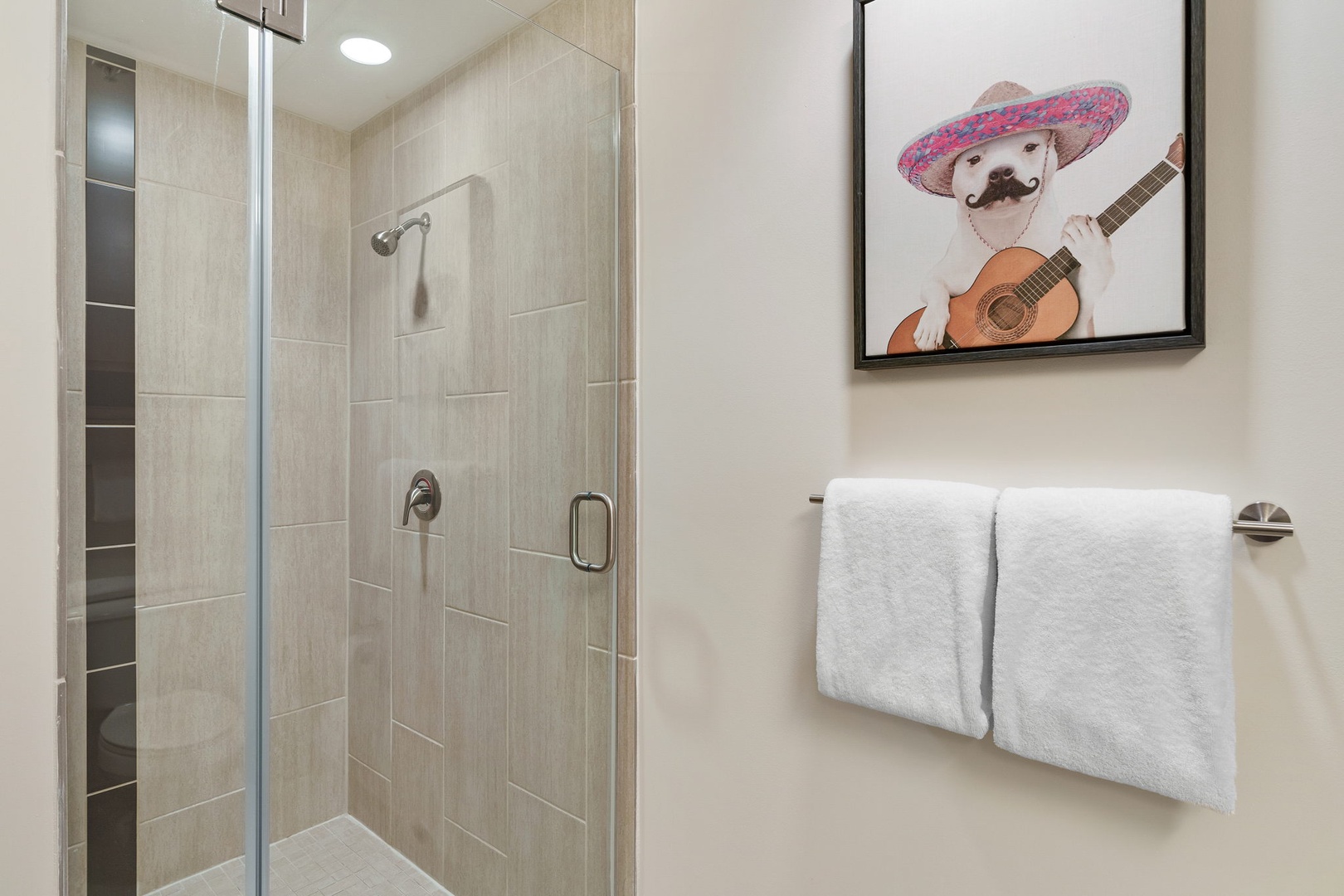 Experience a revitalizing shower in the walk-in shower with modern fixtures.