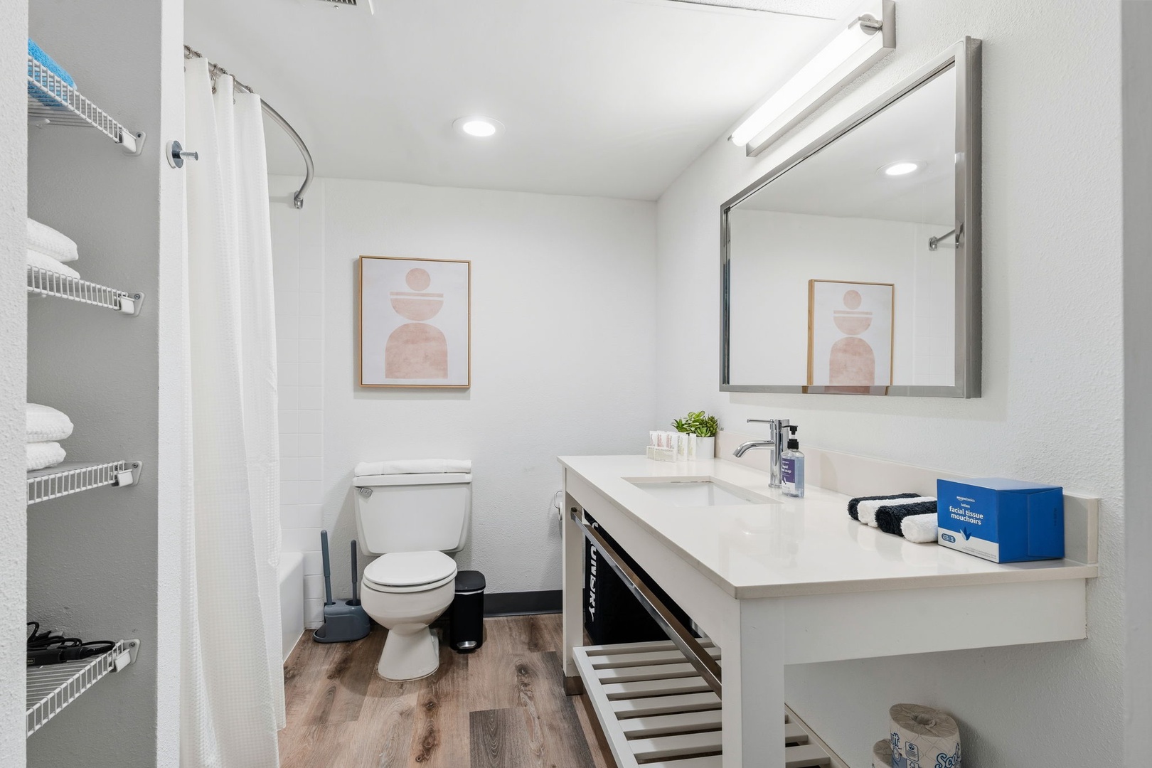 A stocked bathroom with fresh towels and toiletries.